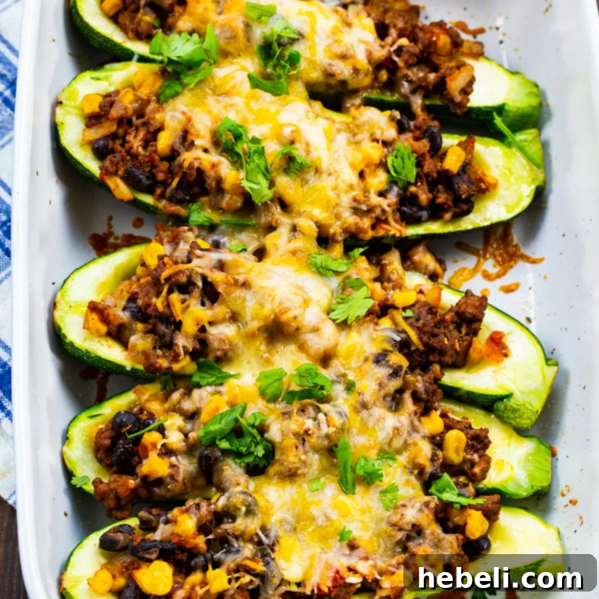 Delicious Taco Zucchini Boats baked to perfection in a ceramic baking dish, ready to be served.