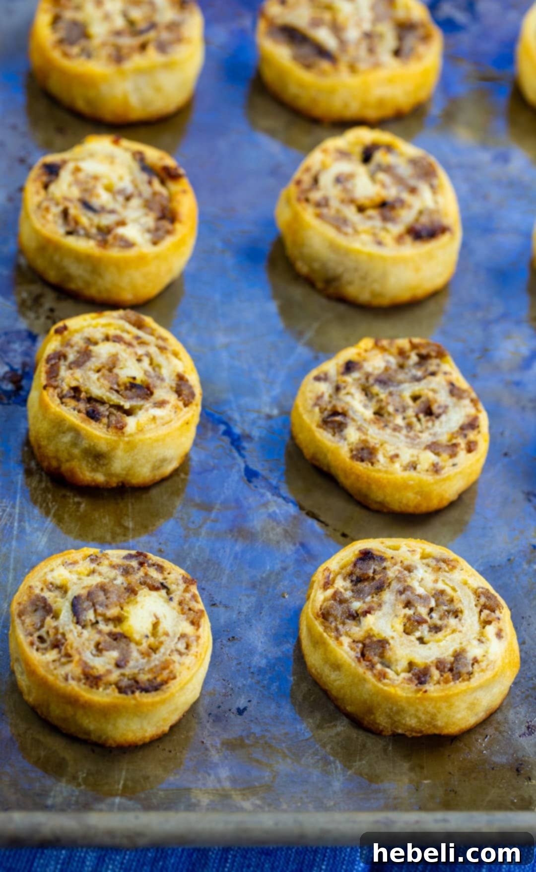Sausage Cream Cheese Pinwheels freshly baked on a baking sheet, golden and inviting.