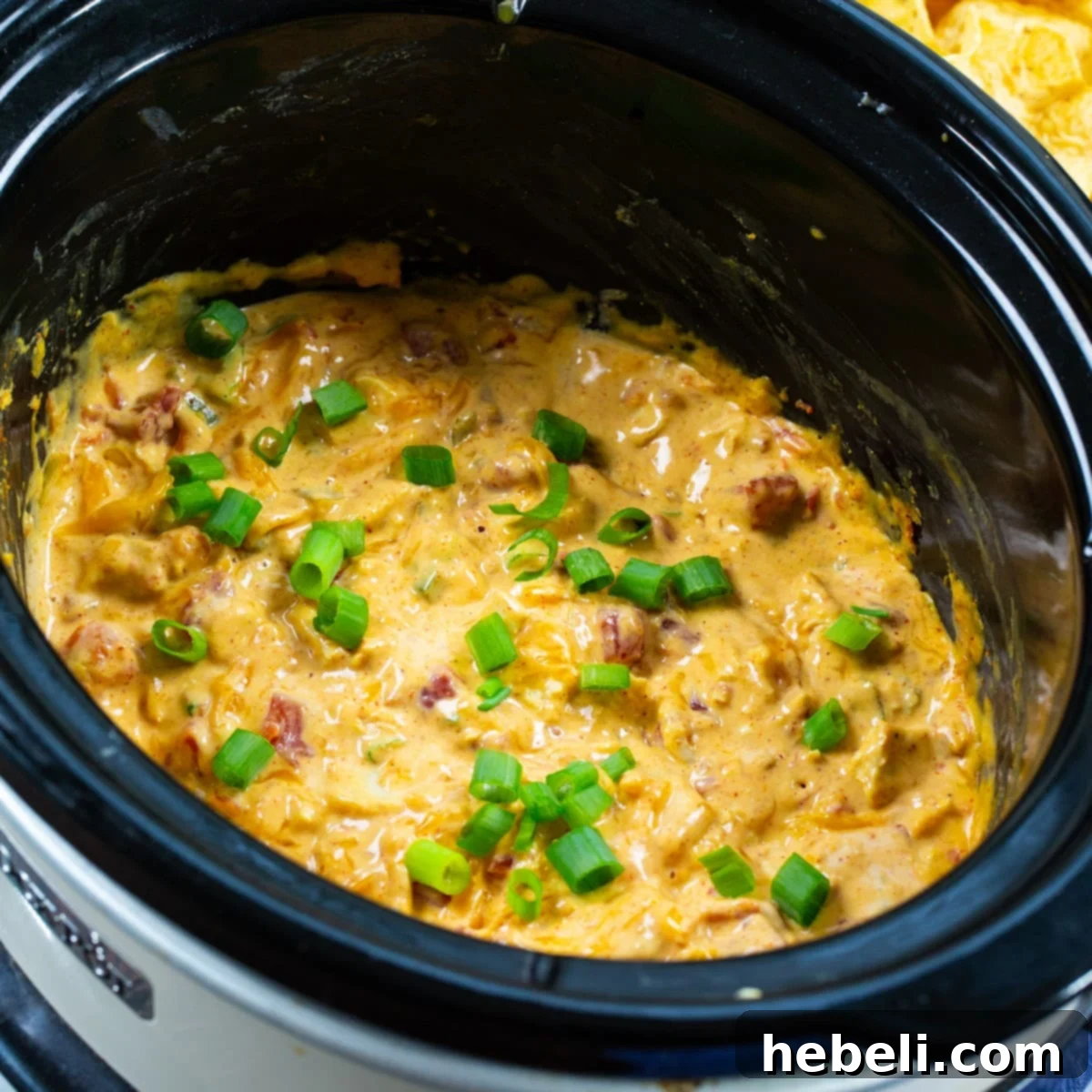 Game Day Slow Cooker Chicken Nacho Dip 2 Rich and creamy Slow Cooker Chicken Nacho Dip ready to serve in a slow cooker.