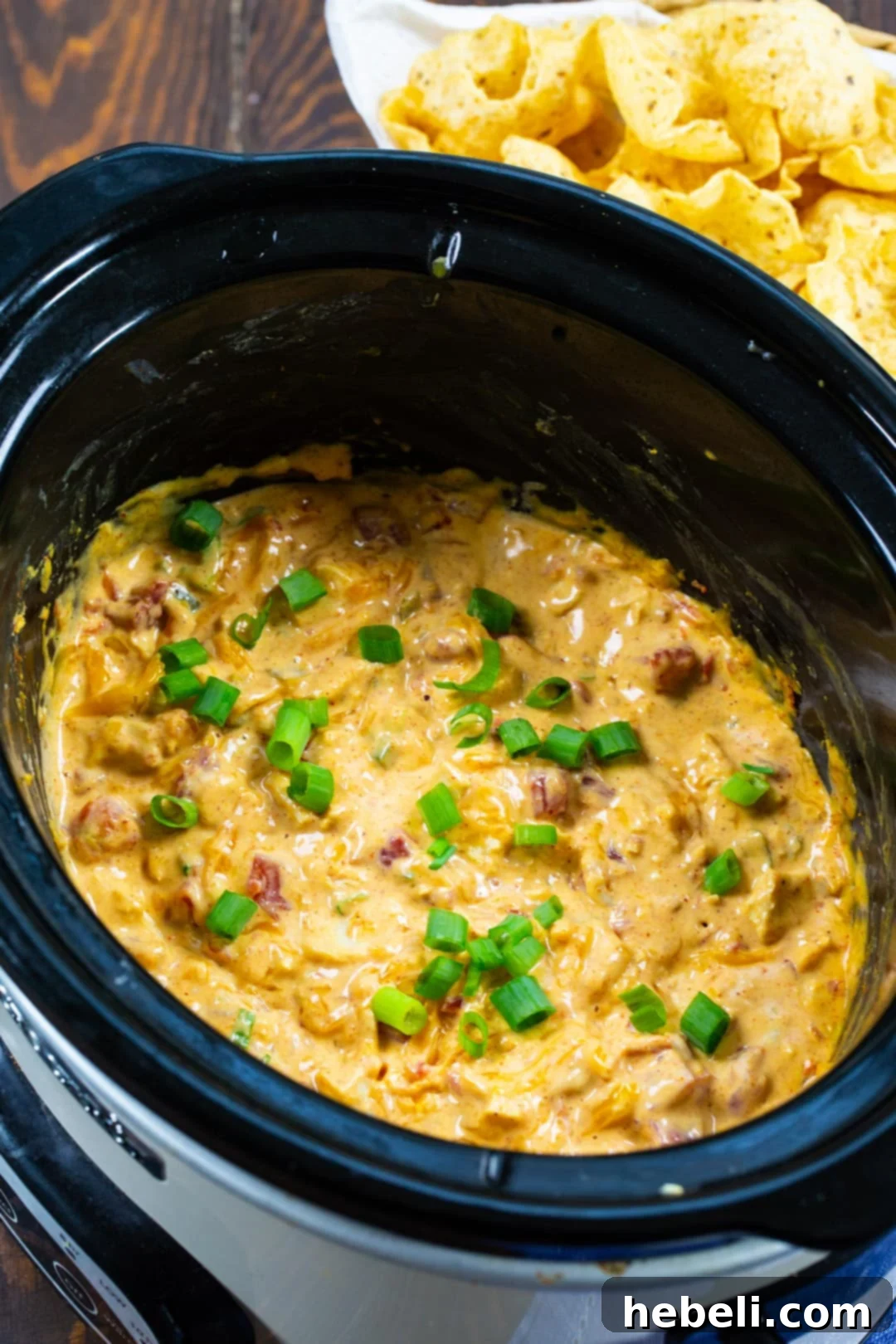 Game Day Slow Cooker Chicken Nacho Dip 3 The Slow Cooker Chicken Nacho Dip simmering in the slow cooker, ready to be served.