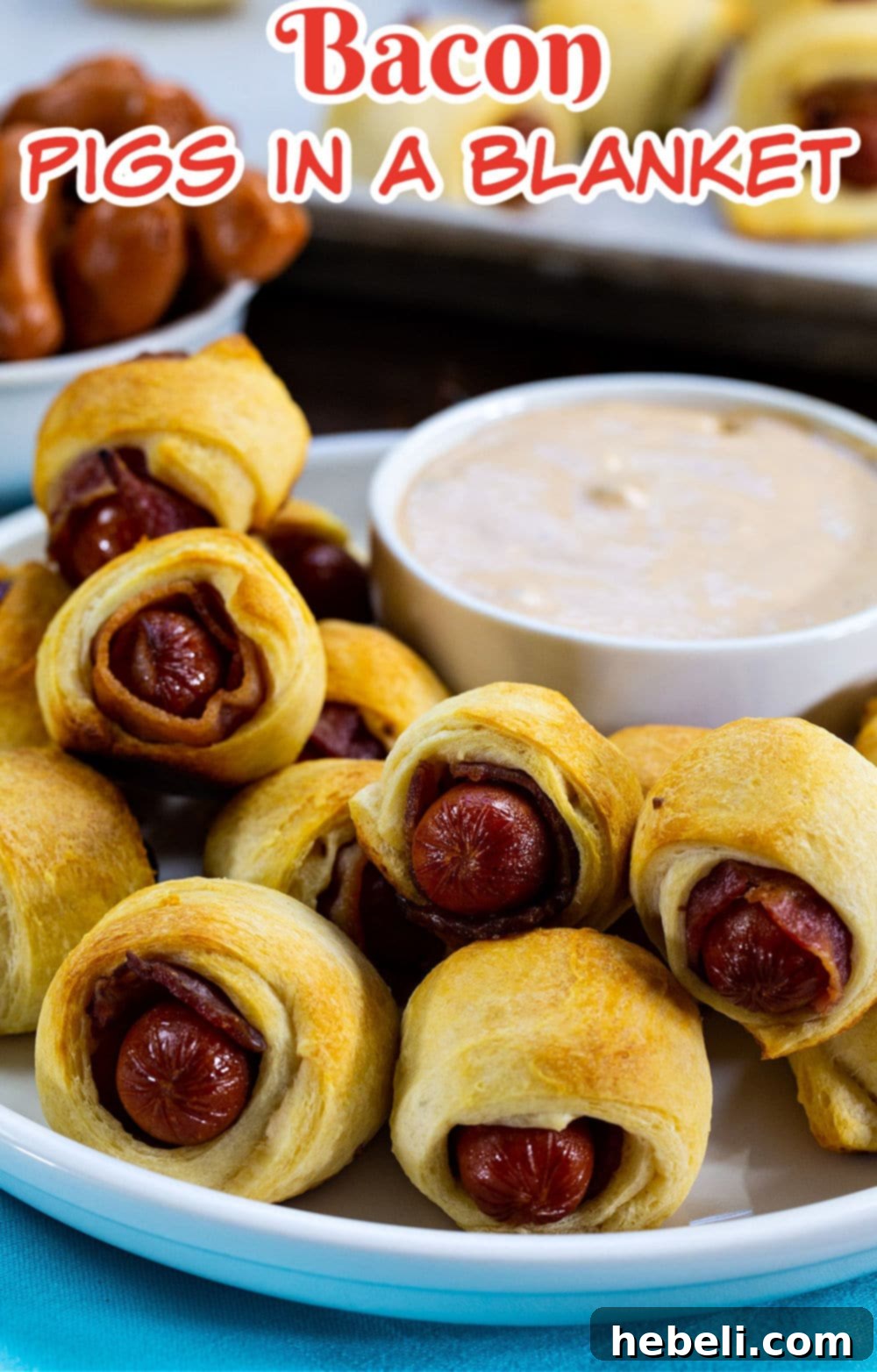 Bacon-Wrapped Sausage Bites 5 Close-up of golden brown Bacon Pigs in a Blanket, perfectly baked and garnished, served with a bowl of BBQ Ranch dipping sauce.