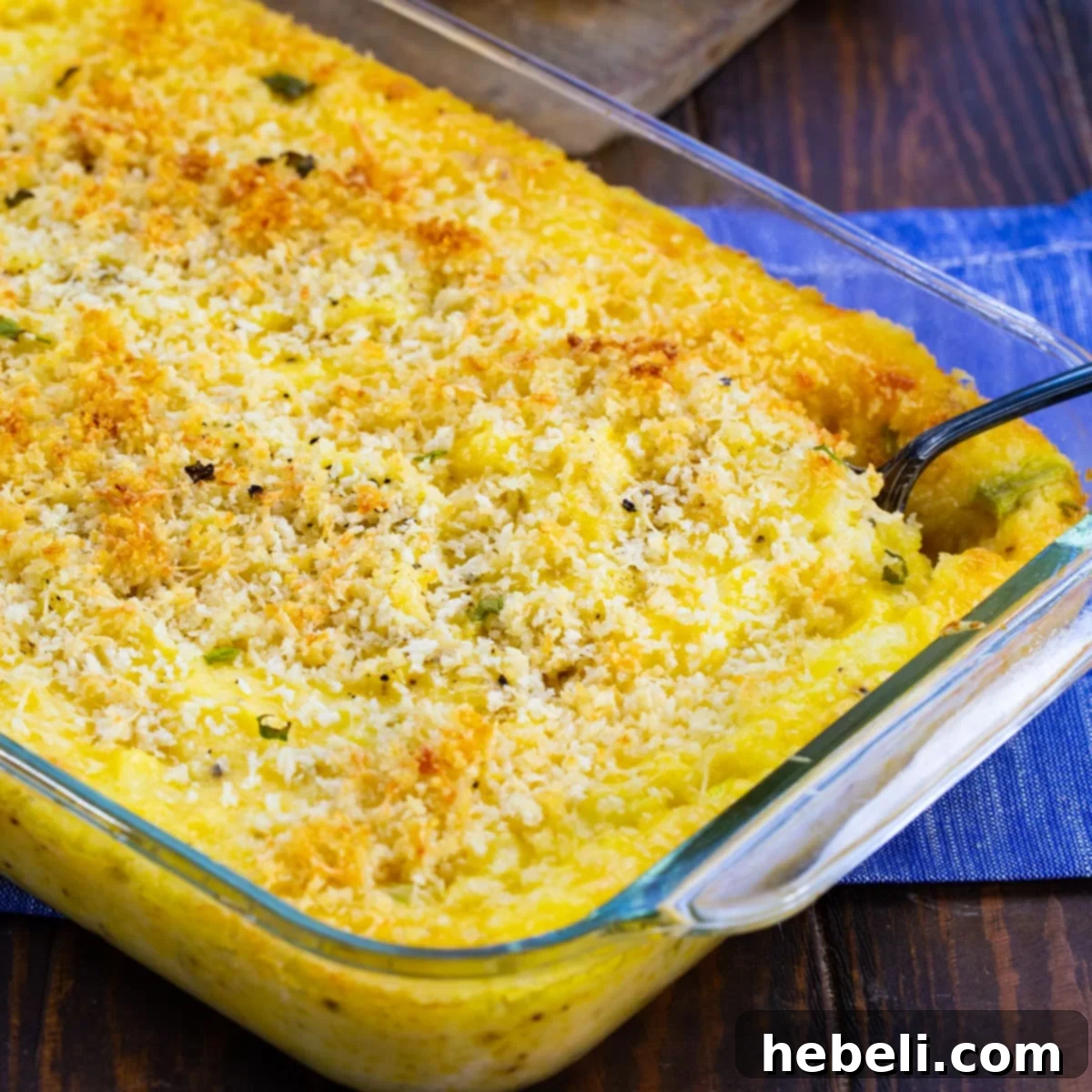 Creamy Cheesy Potato Bake 2 A golden-brown Cheesy Mashed Potato Casserole in a baking dish, fresh from the oven, with bubbling cheese.