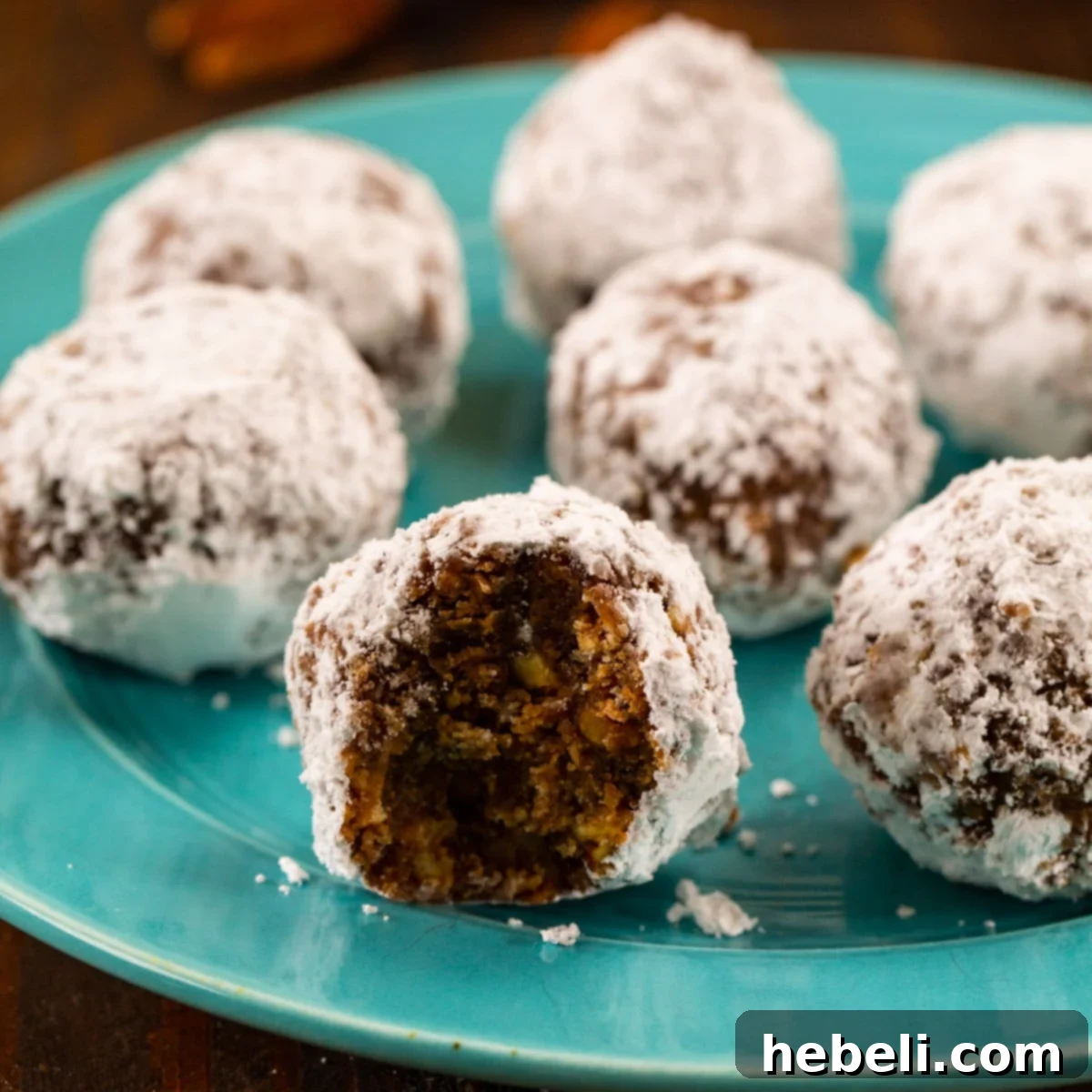 Vanilla Wafer Bourbon Balls beautifully arranged on a white serving plate, dusted with powdered sugar.