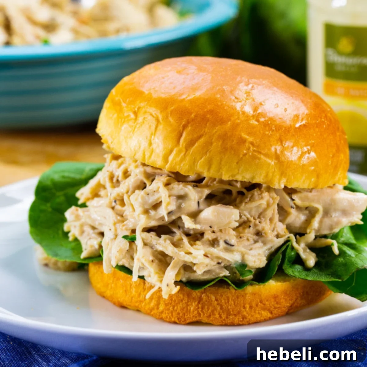 Instant Pot Zesty Caesar Chicken 2 Instant Pot Caesar Chicken on a bun with lettuce.