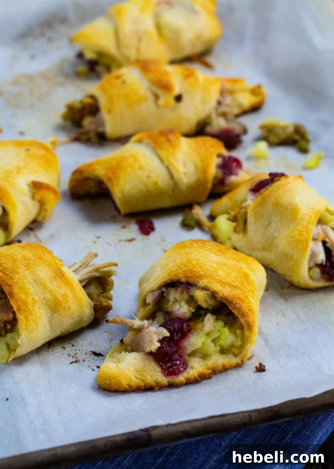 Delicious Thanksgiving Crescent Rolls 3 A large baking sheet filled with freshly baked, golden-brown Thanksgiving Crescent Rolls, steam gently rising.