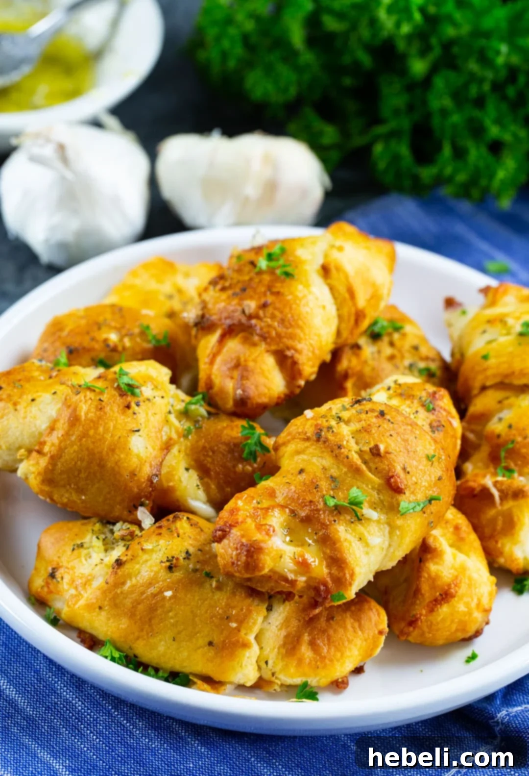 A plate of freshly air-fried Cheesy Garlic Crescent Rolls, golden and inviting.