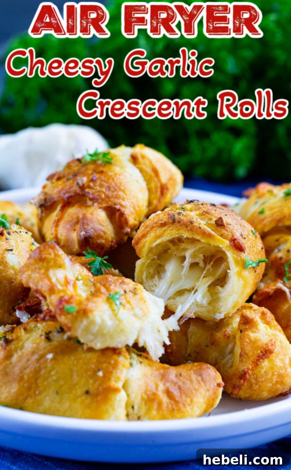 An Air Fryer Cheesy Garlic Crescent Roll cut open, showcasing the gooey melted cheese filling.