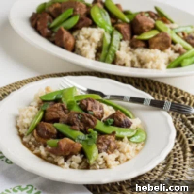 Close-up of Slow Cooker Five Spiced Pork with Sugar Snap Peas, perfect for serving.