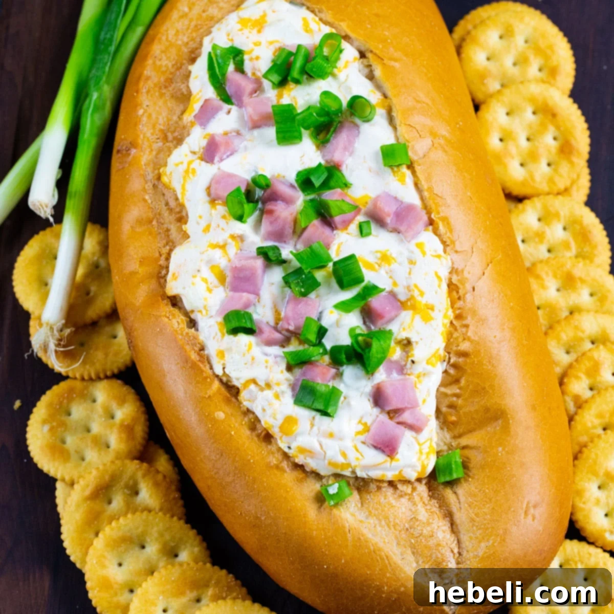 Irresistible Mississippi Sin Dip 2 Mississippi Sin Dip in a bread bowl surrounded by crackers.