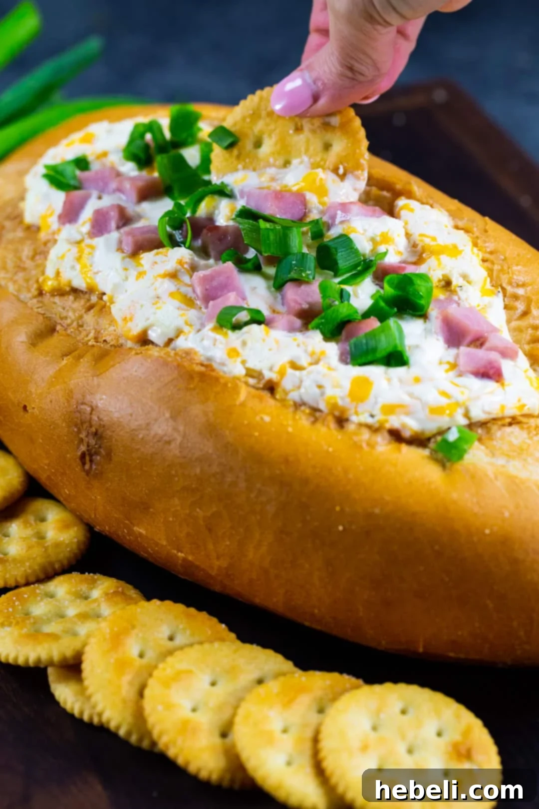 Irresistible Mississippi Sin Dip 5 Cracker getting dipped into the dip.