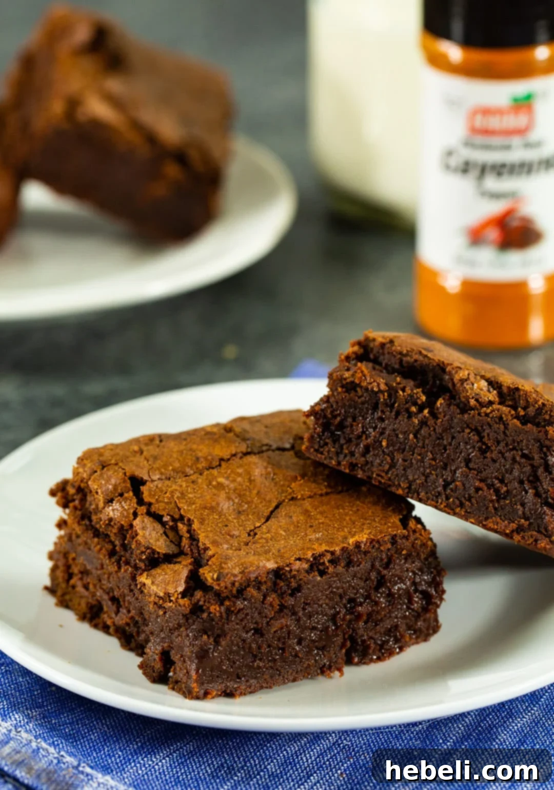 Fiery Fudge Delights 4 Two perfectly cut spicy chocolate brownies on a white plate.