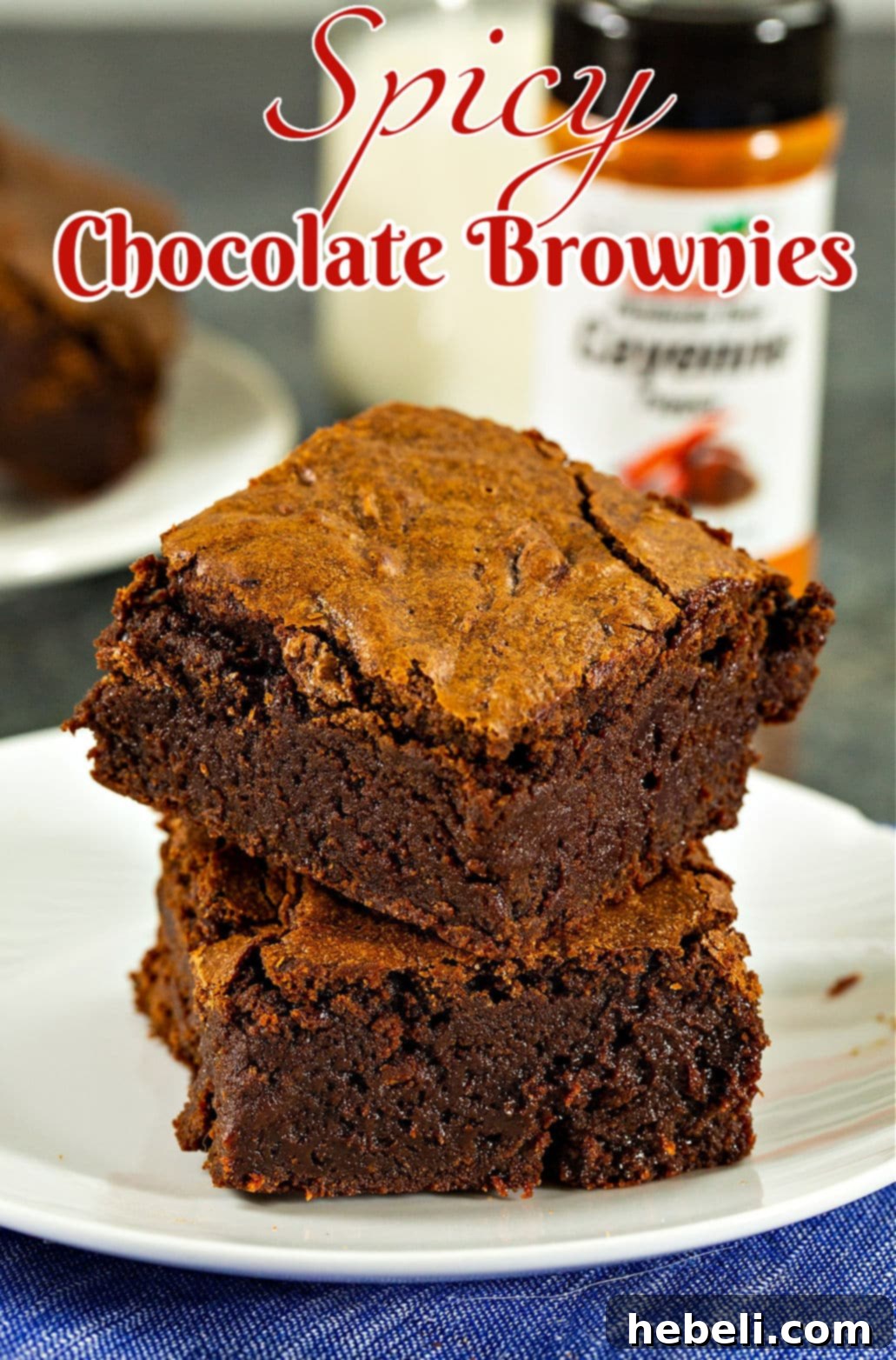 Fiery Fudge Delights 5 Two spicy chocolate brownies stacked elegantly on a white plate.