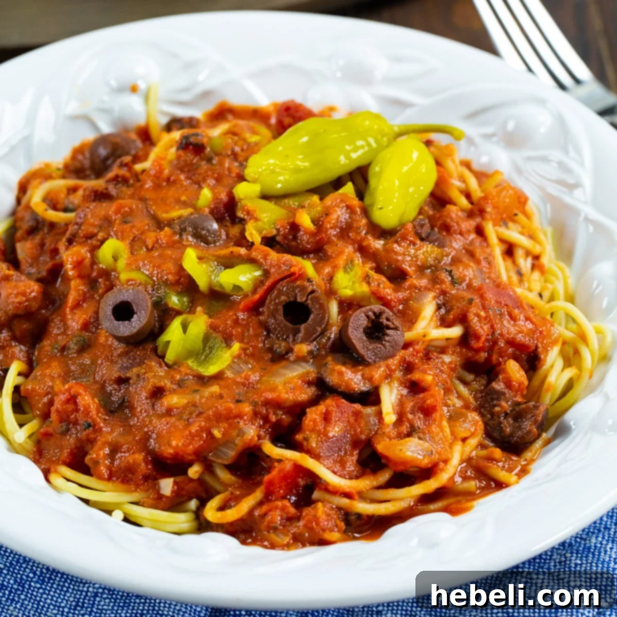 Pepperoncini Pasta Sauce over spaghetti in a bowl.