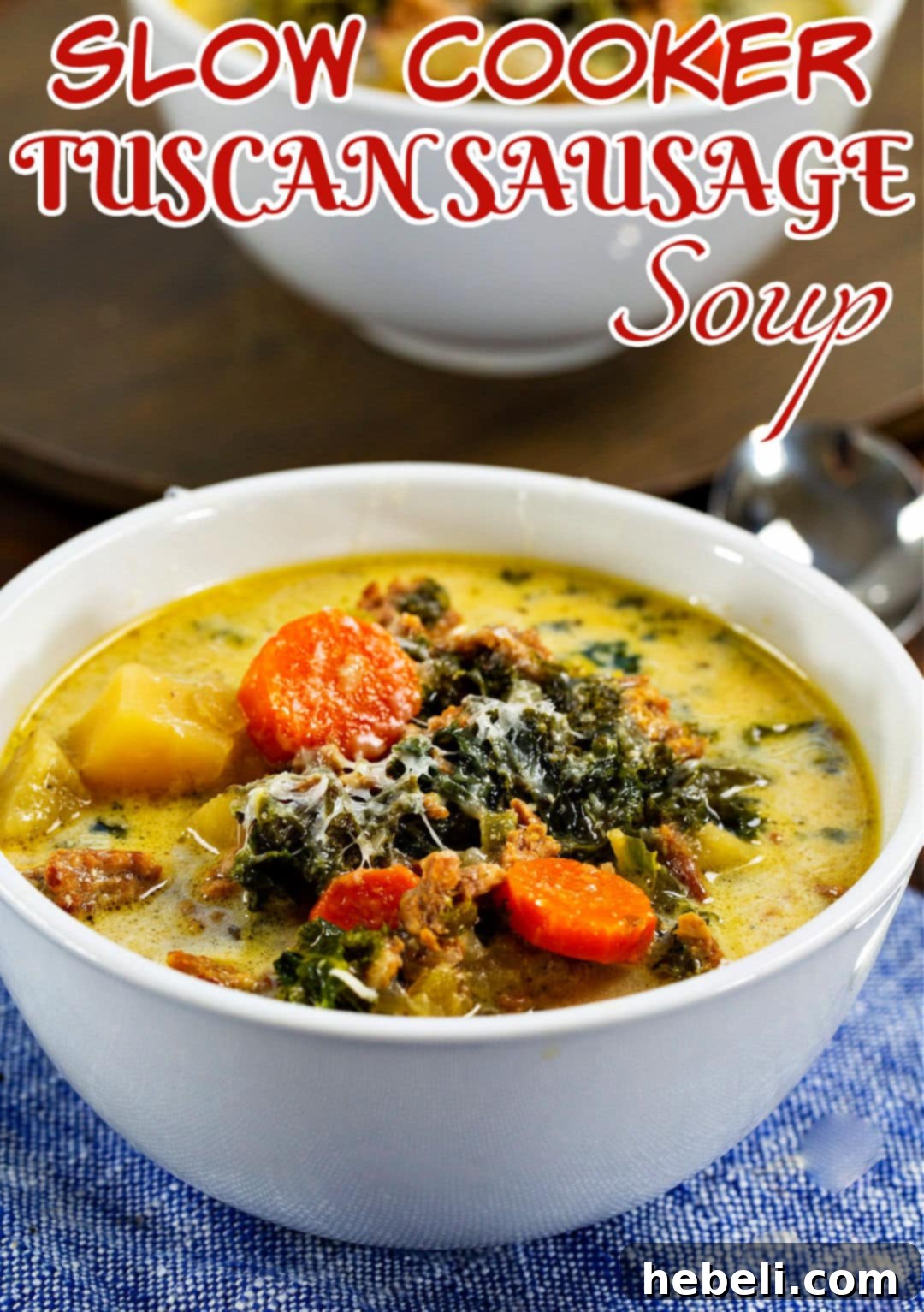 Close-up of Slow Cooker Tuscan Sausage Soup in a bowl with grated Parmesan cheese.