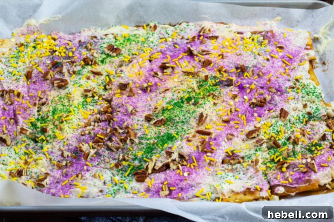 King Cake Toffee Bark 3 Cracker Candy on baking sheet, freshly baked and ready for chocolate topping.