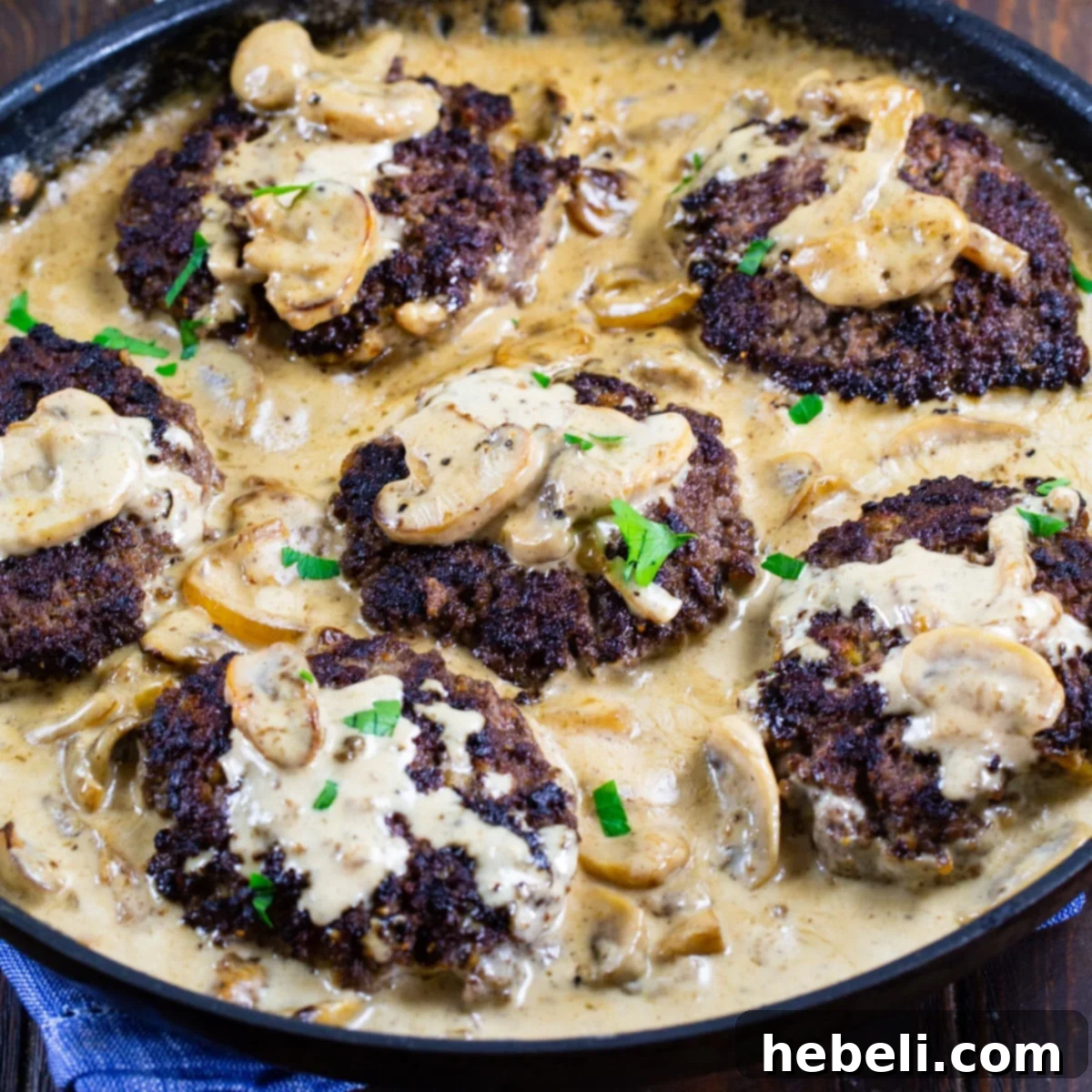 Bourbon Mushroom Gravy Hamburger Steaks 2 Hamburger Steaks with Bourbon Mushroom Gravy in a skillet, ready to serve.