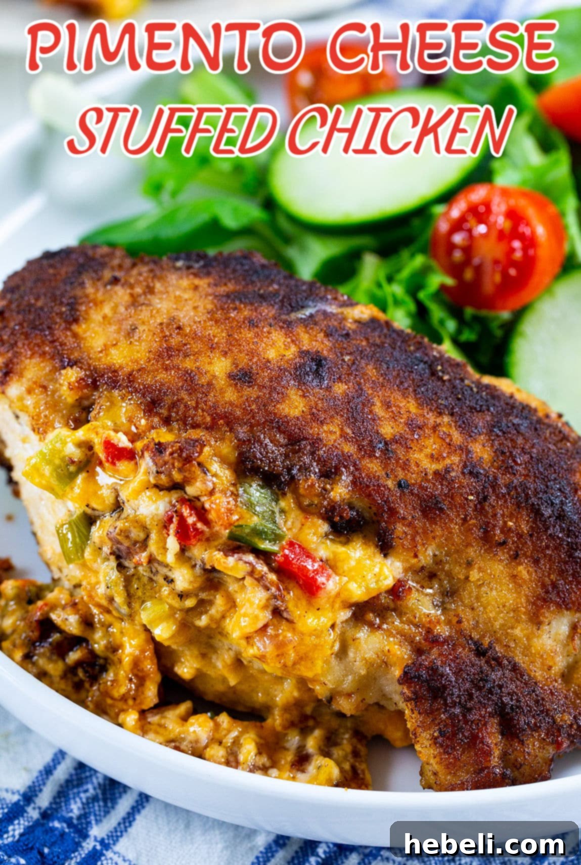 Creamy Pimento Cheese Stuffed Chicken 5 Individual serving of Pimento Cheese Stuffed Chicken on a white plate, garnished with fresh herbs.