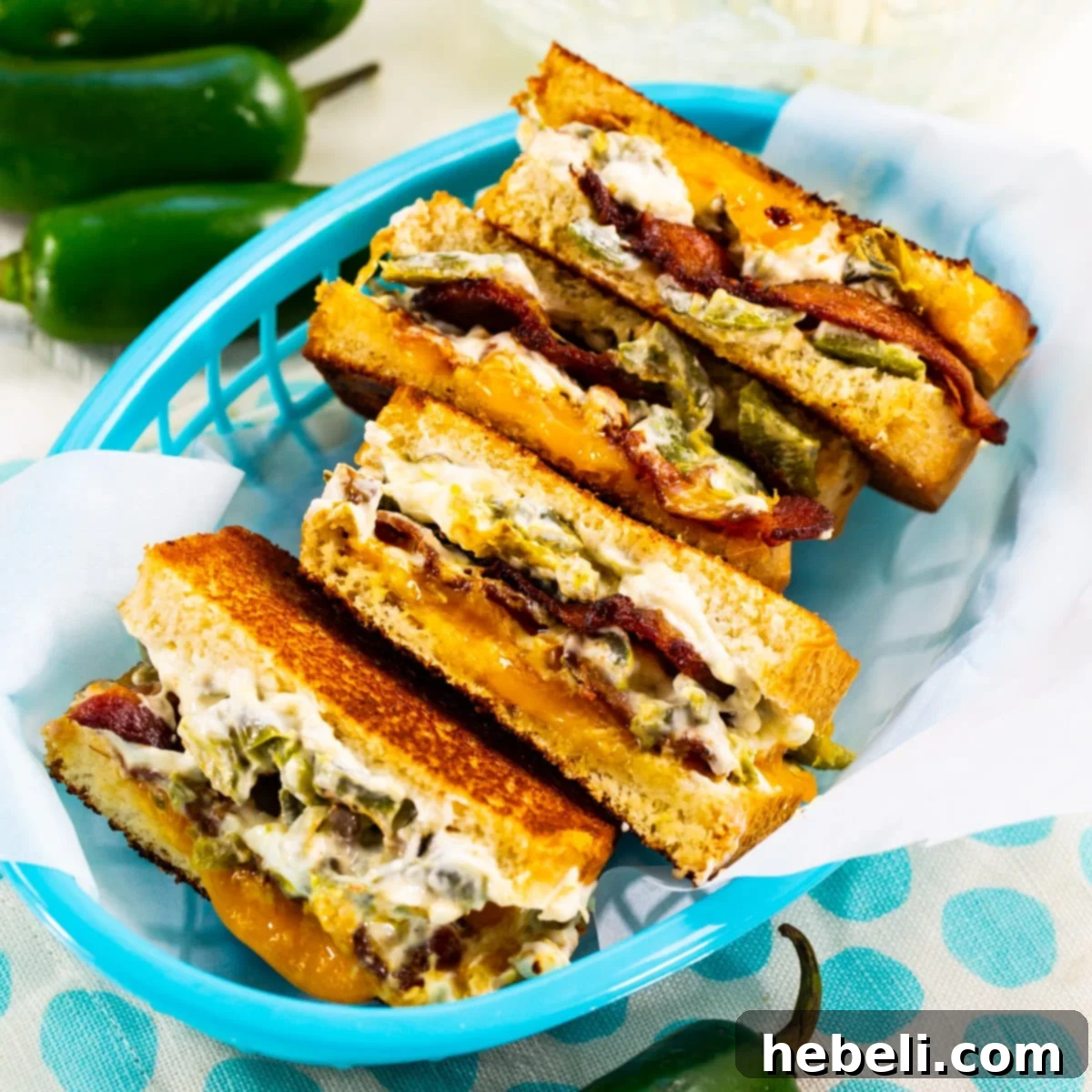 A delectable Jalapeno Popper Grilled Cheese sandwich served in a charming blue basket, highlighting its golden-brown crust and inviting cheesy filling.