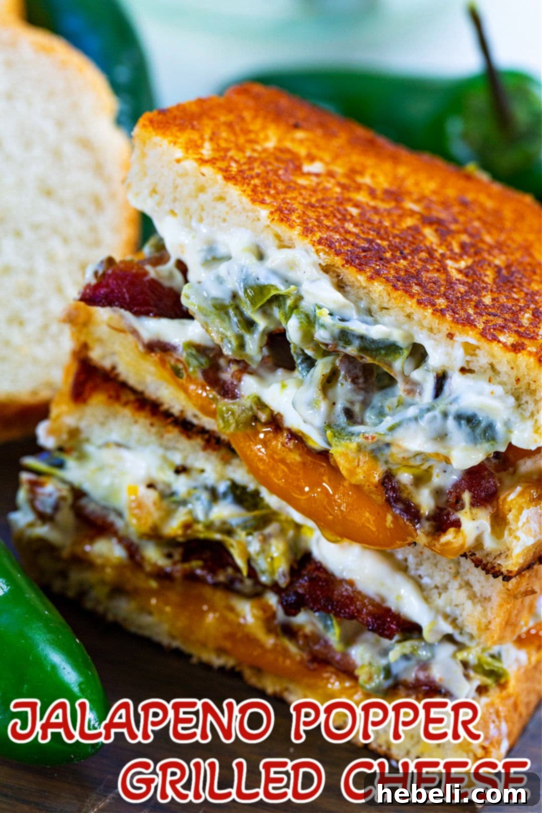 Stacked halves of Jalapeno Popper Grilled Cheese, showcasing the thick, cheesy filling and golden-brown bread, enticingly ready to be enjoyed.