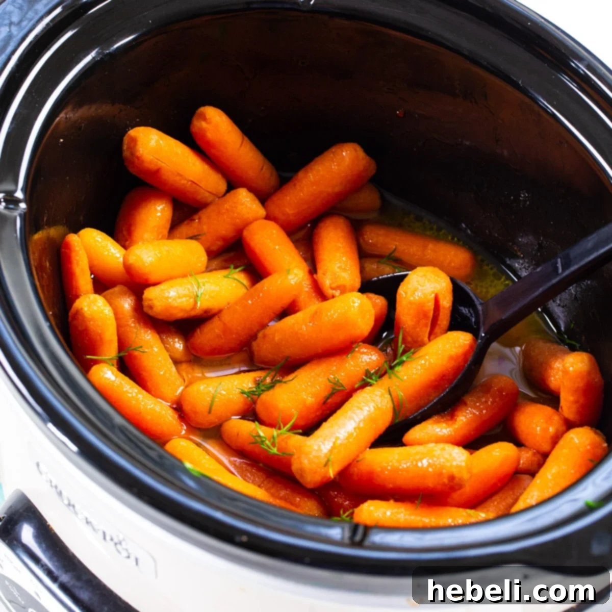 Slow Cooker Baby Carrots in slow cooker, glistening with glaze.