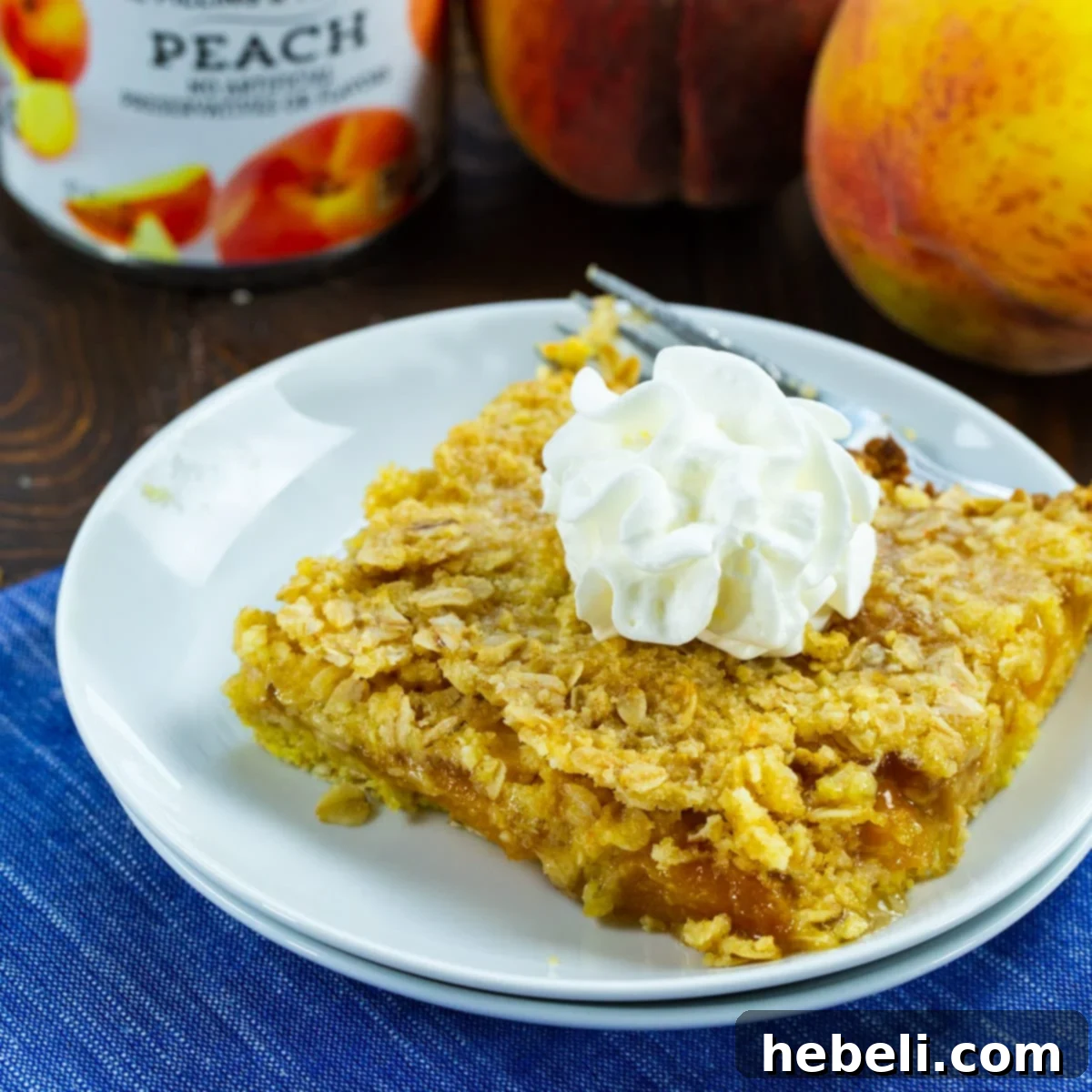 Lush peach bar topped with a swirl of whipped cream, inviting a sweet indulgence.
