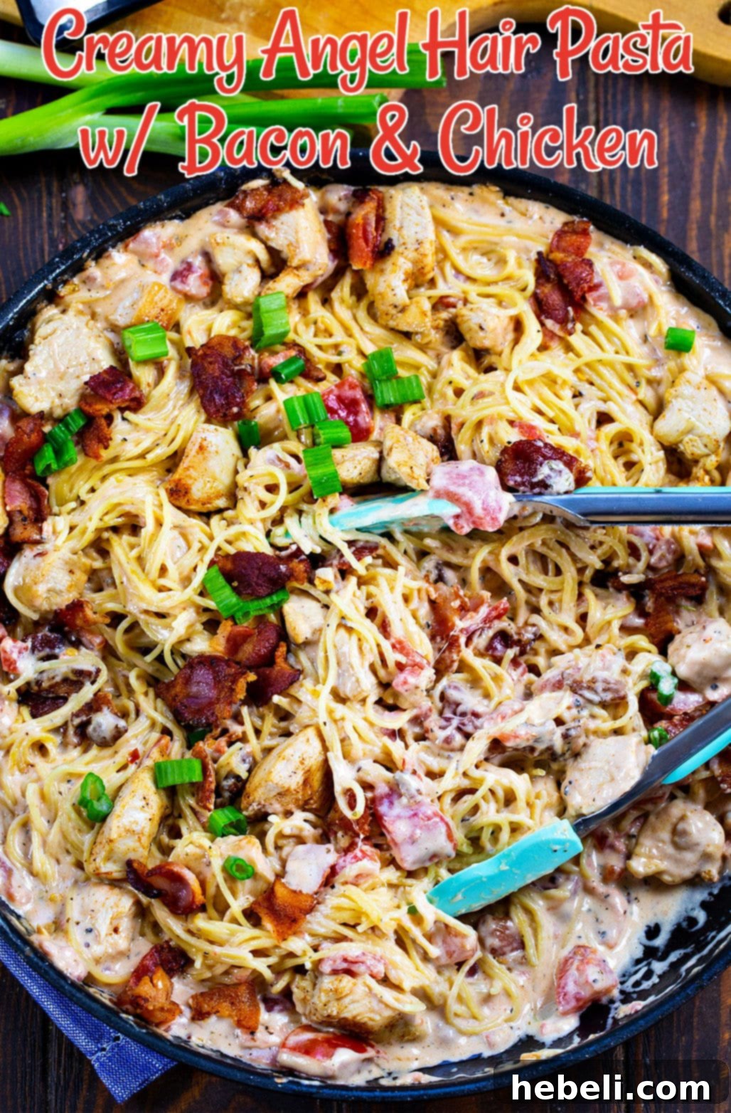 Creamy Angel Hair Pasta with Bacon and Chicken being served from a large skillet with tongs, emphasizing its hearty portions.