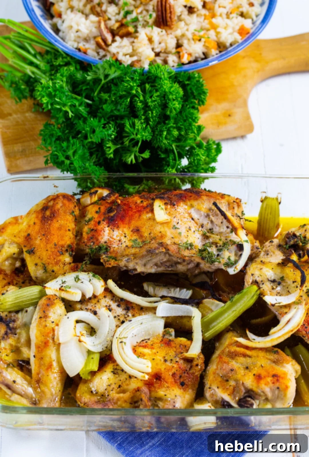 Classic Southern Baked Chicken 4 Perfectly cooked Southern Baked Chicken, golden and glistening with pan juices, in a baking dish.