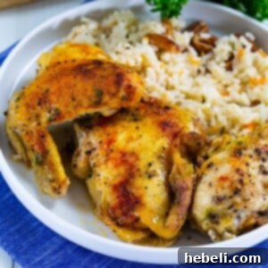 Close-up of baked chicken in a dish, golden brown and juicy.