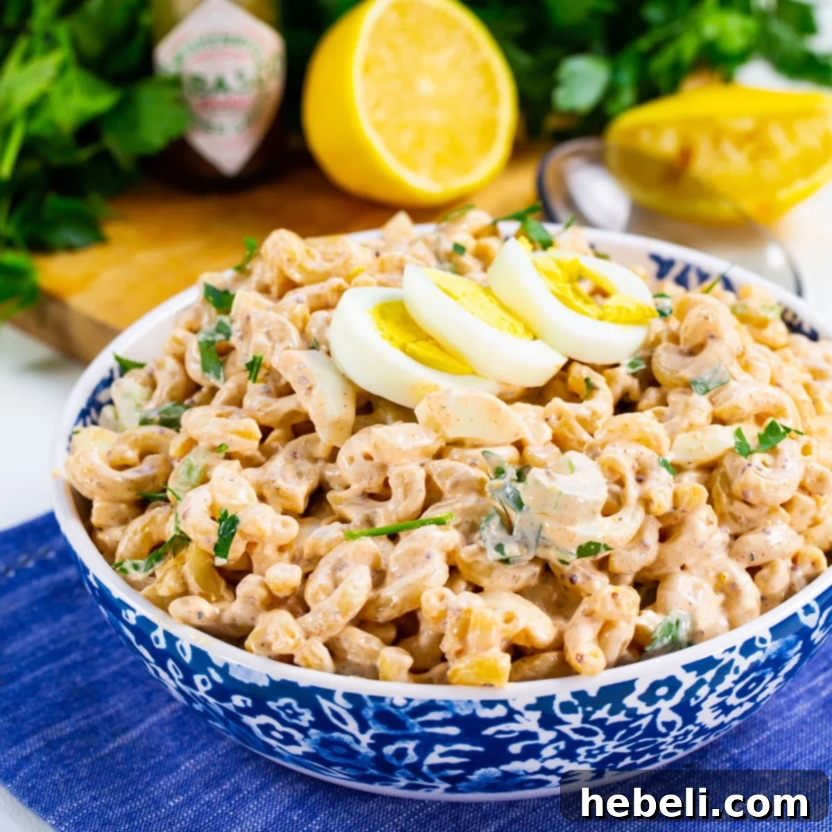 Kickin' Cajun Macaroni Salad 2 A vibrant serving bowl filled with Cajun Macaroni Salad, garnished and ready to enjoy.