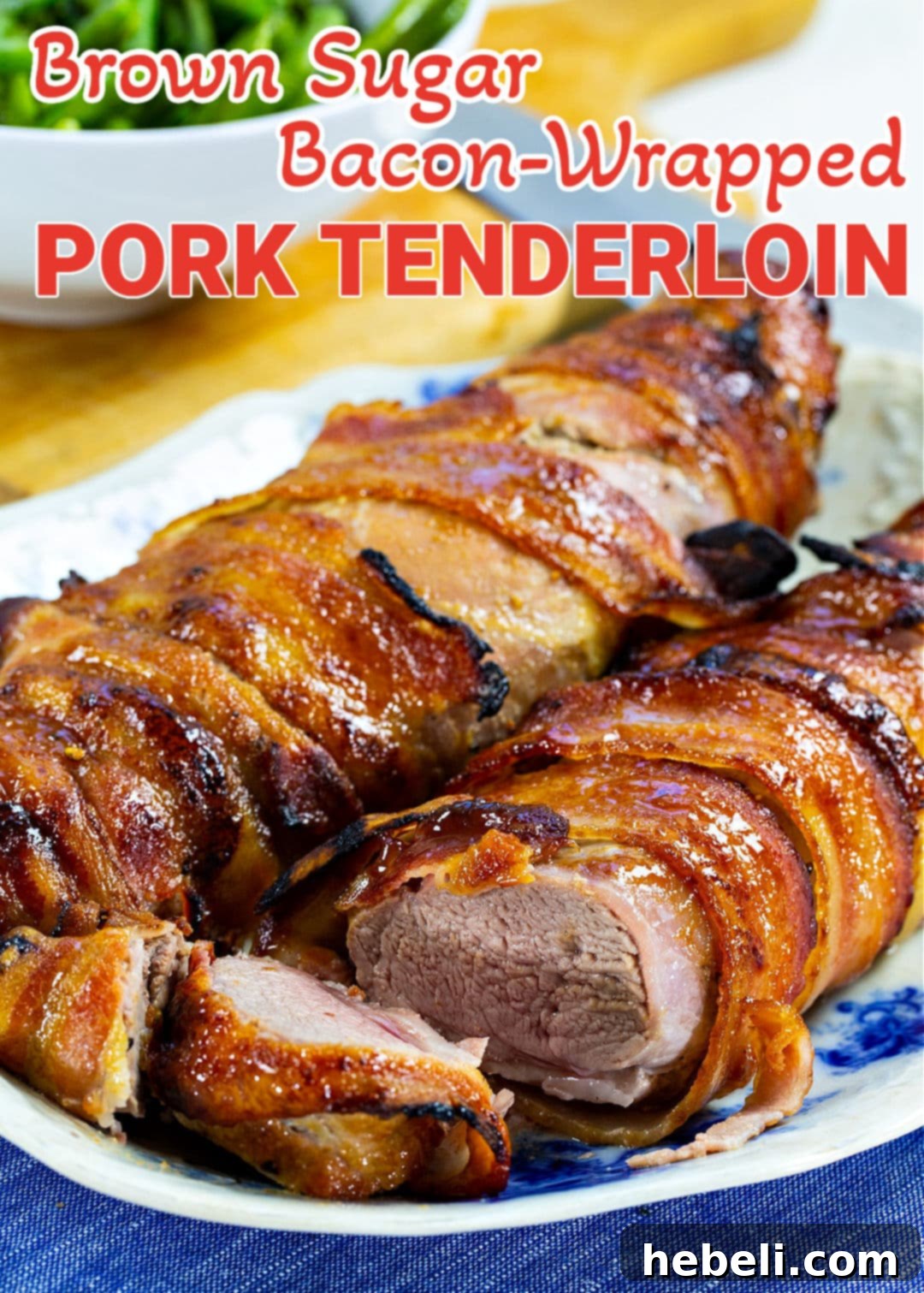 Close-up of perfectly sliced Brown Sugar Bacon Wrapped Pork Tenderloin, revealing tender meat and crispy bacon.