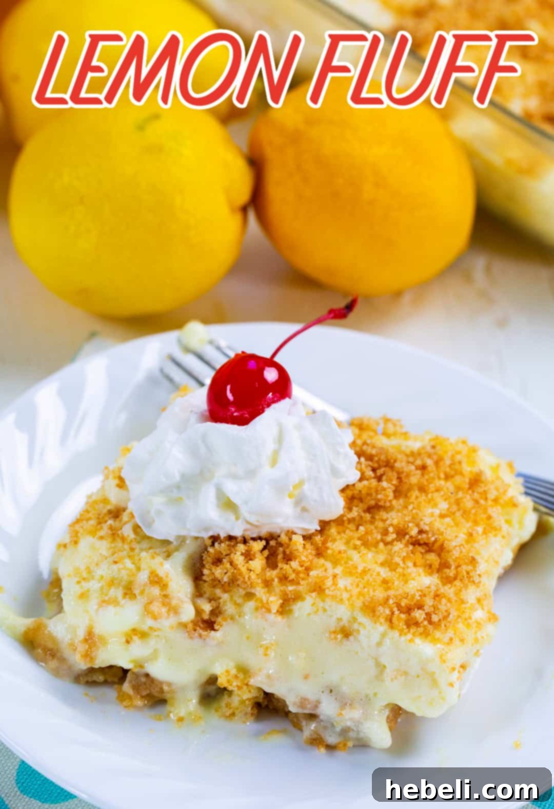 A simple yet elegant slice of Lemon Fluff dessert presented on a white plate, highlighting its smooth texture and golden-brown vanilla wafer crust.