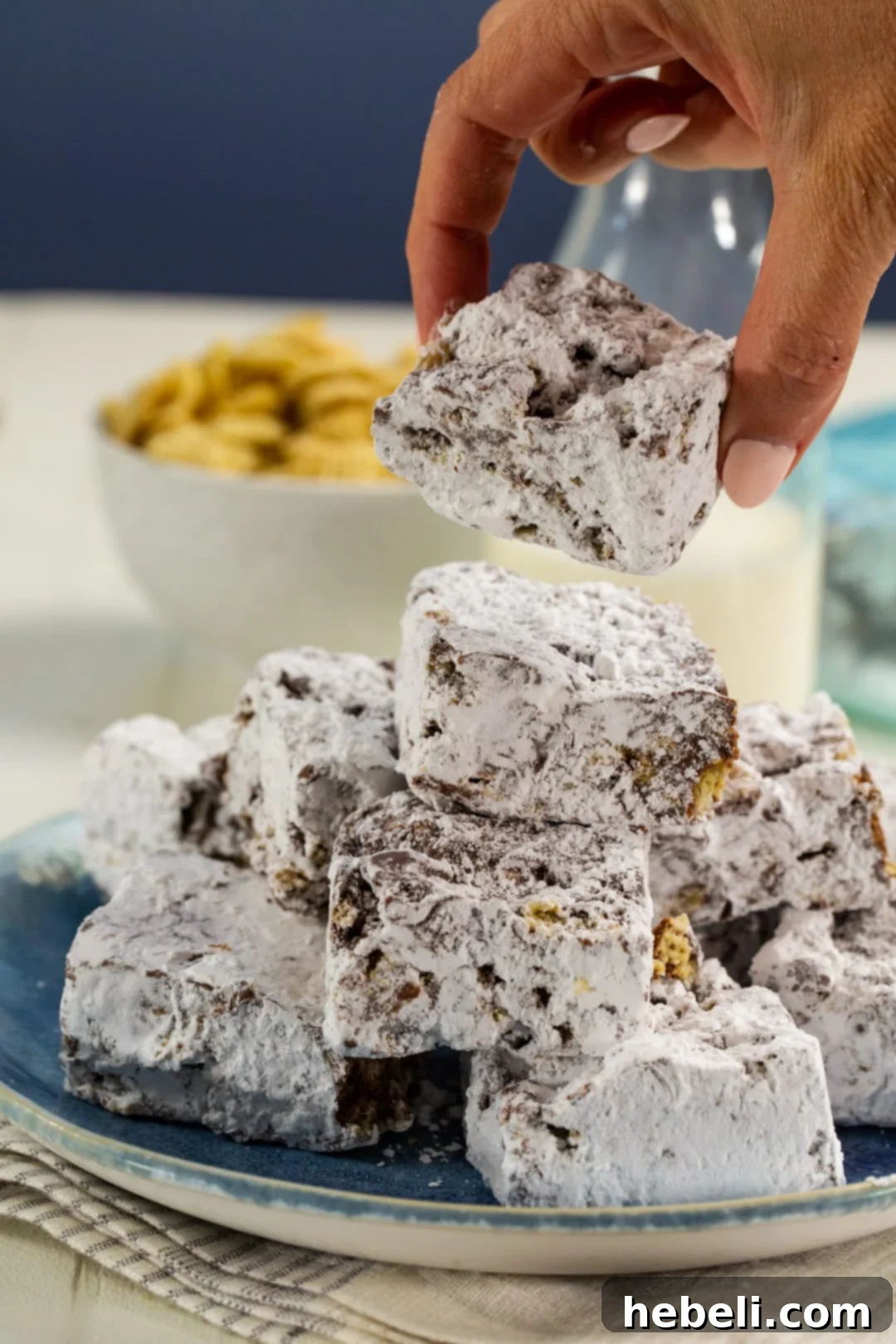 Hand picking up a Muddy Buddy Bar, ready to enjoy.