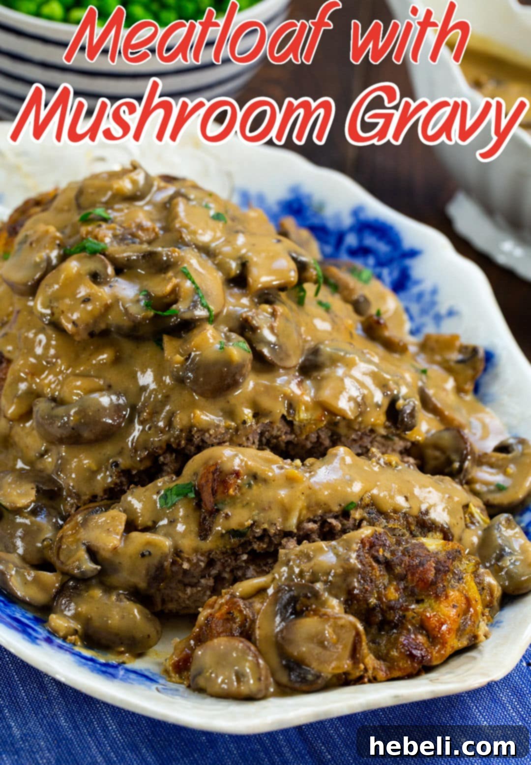 A freshly baked meatloaf, generously coated in rich mushroom gravy, ready to be served from a platter.