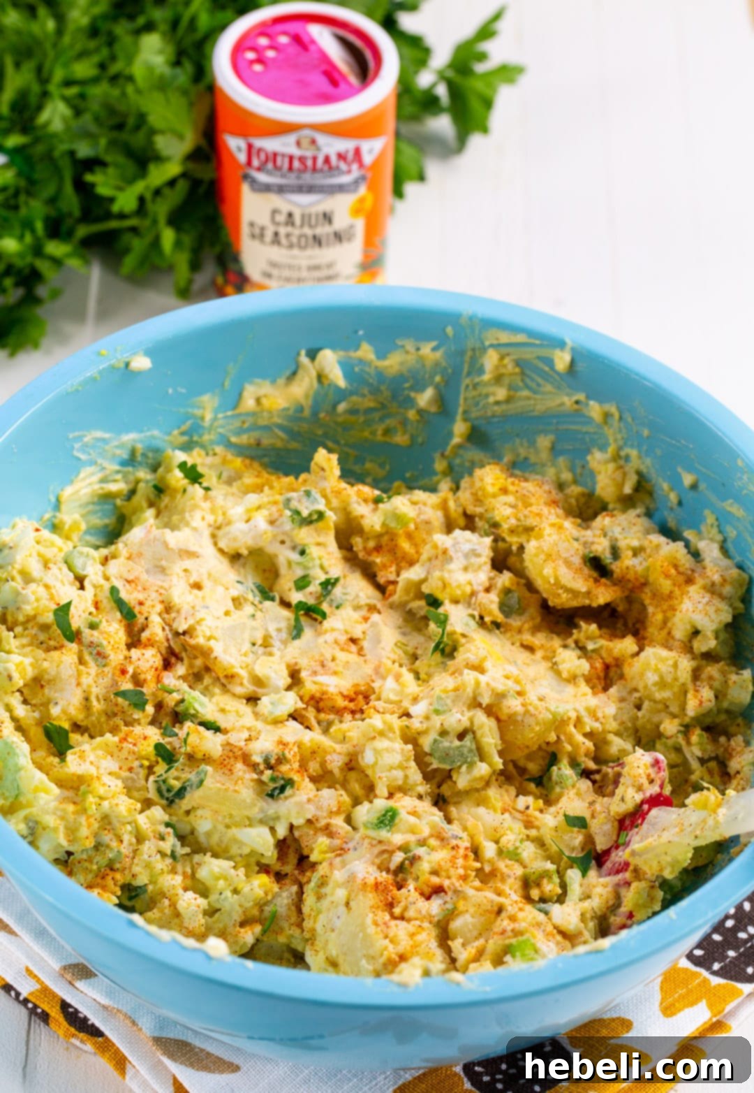 Cajun Kick Potato Salad 3 Mixing Cajun Potato Salad ingredients in a large bowl.