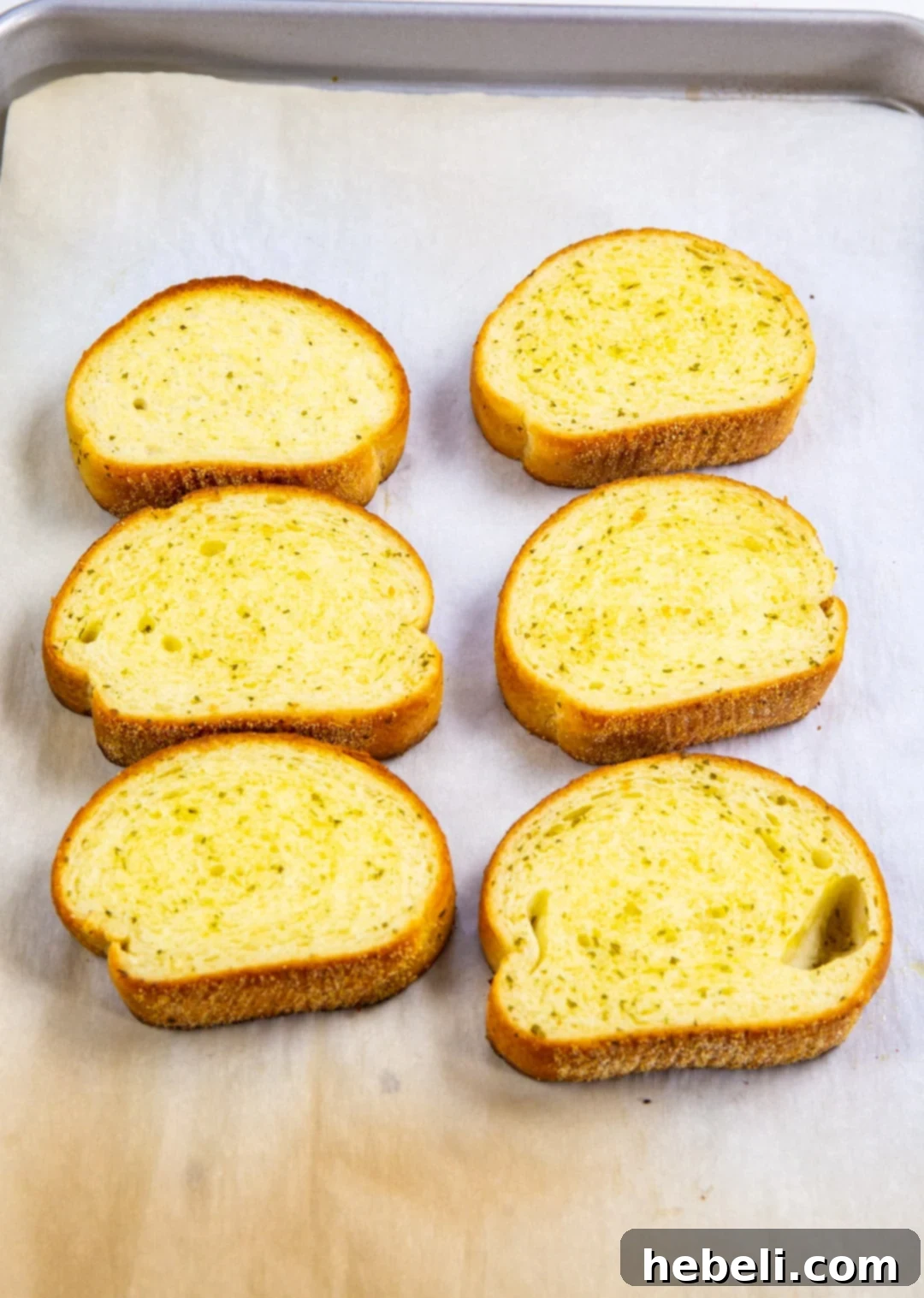 Loaded Texas Toast Sloppy Joes 5 Six pieces of Texas Toast Garlic Bread laid out on a baking sheet, ready for toppings.
