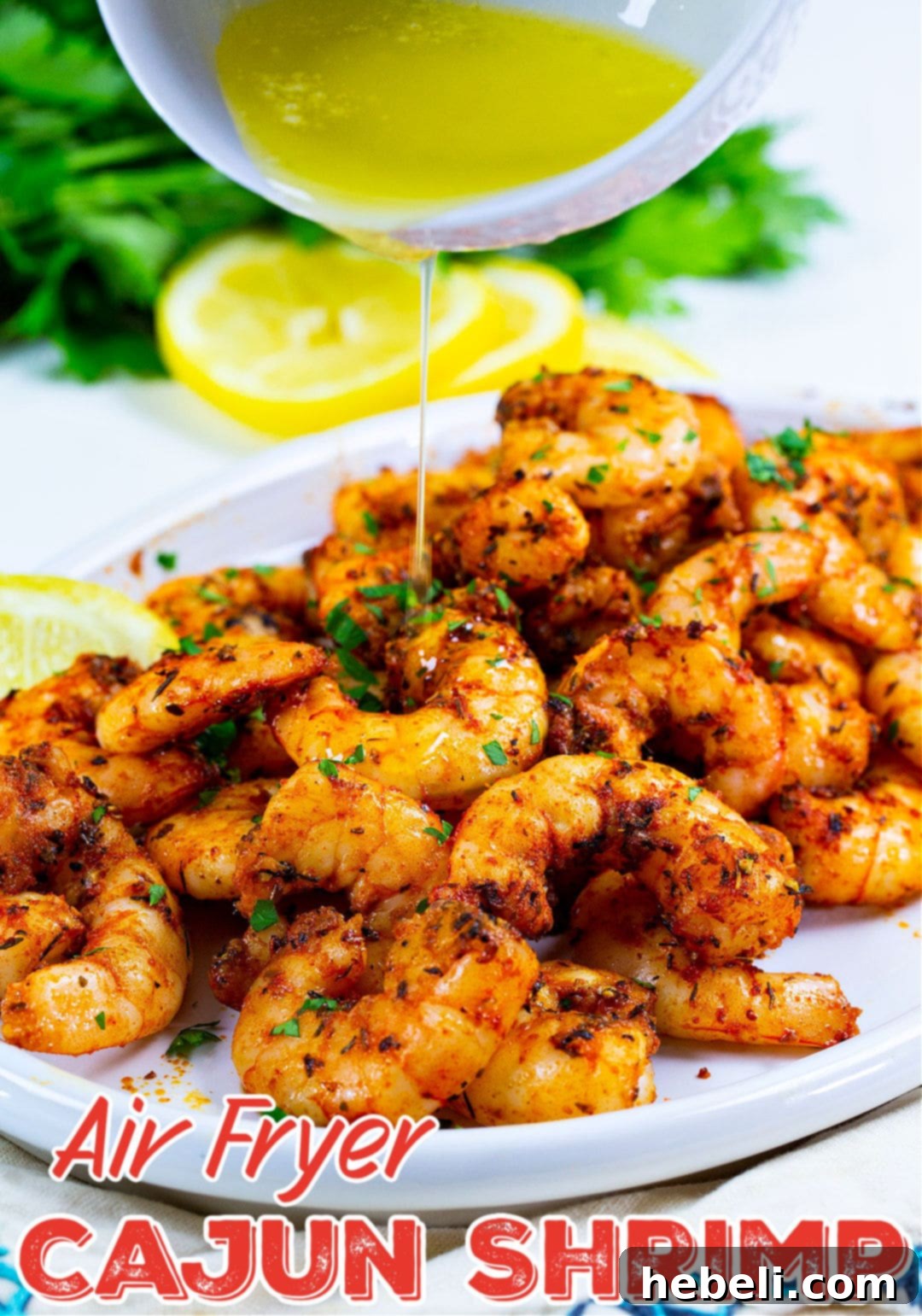 Melted butter being drizzled over a bowl of freshly cooked Air Fryer Cajun Shrimp, enhancing flavor and moisture.