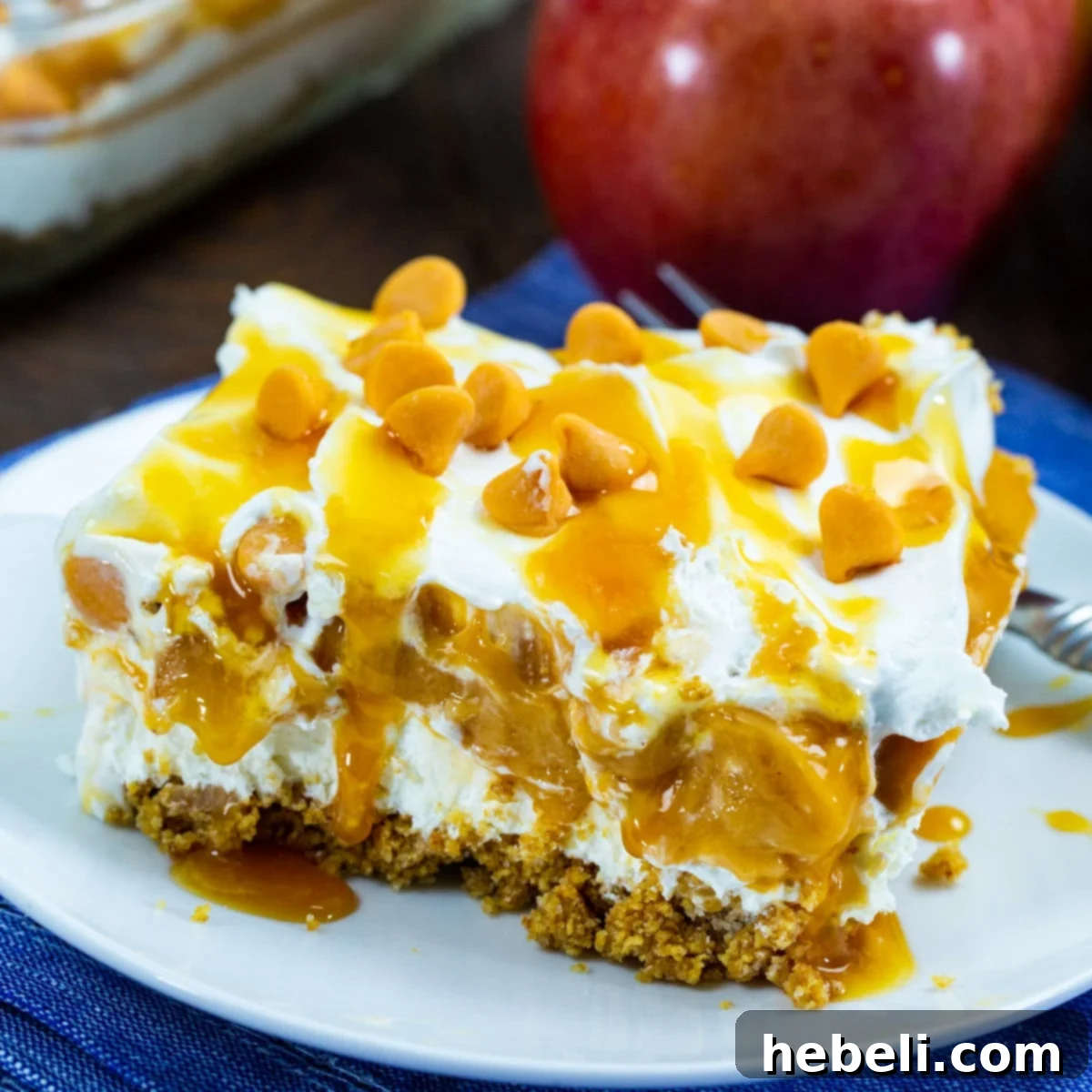 A delectable slice of No-Bake Caramel Apple Lush on a plate, showcasing its beautiful layers.