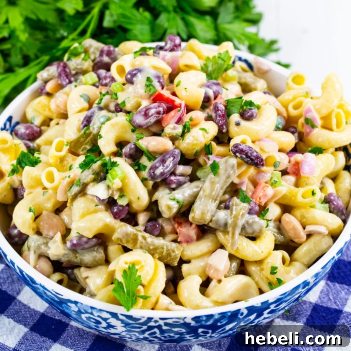 Hearty Three Bean Pasta Salad 2 A vibrant bowl of 3-Bean Pasta Salad, showcasing the pasta, three types of beans, and colorful vegetables, ready for serving.