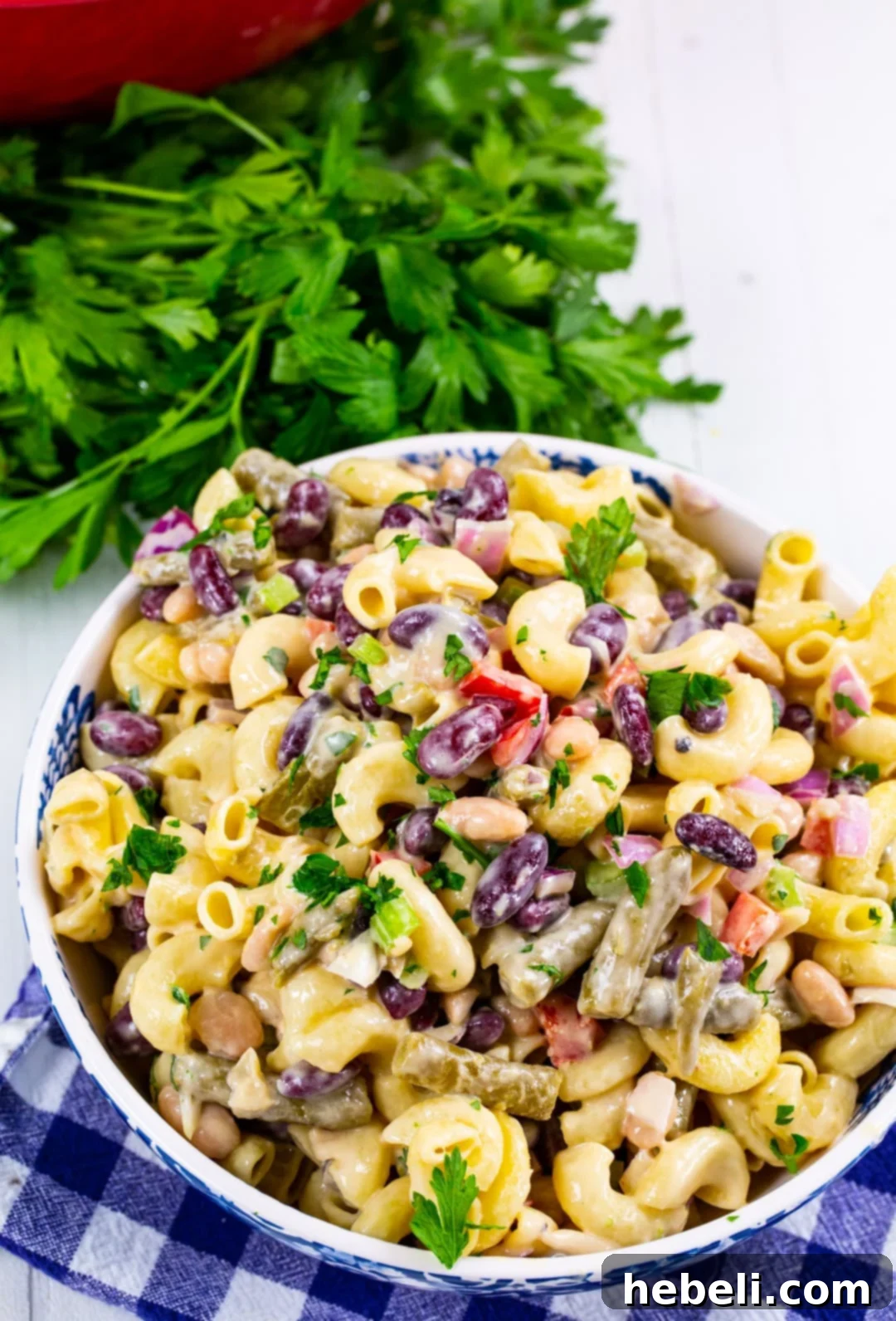Hearty Three Bean Pasta Salad 4 A close-up shot of 3-Bean Pasta Salad in a serving bowl, highlighting the creamy dressing, pasta, and colorful bean varieties.