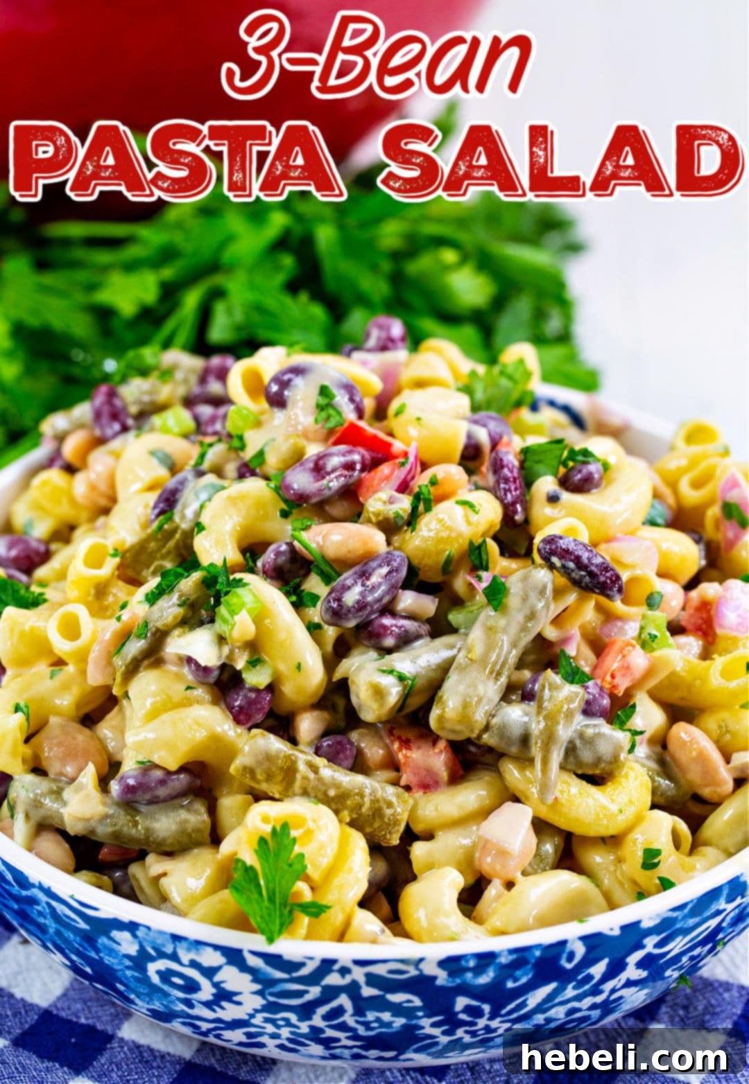 Hearty Three Bean Pasta Salad 5 A large serving bowl filled with 3-Bean Pasta Salad, garnished with fresh parsley, ready for a gathering.