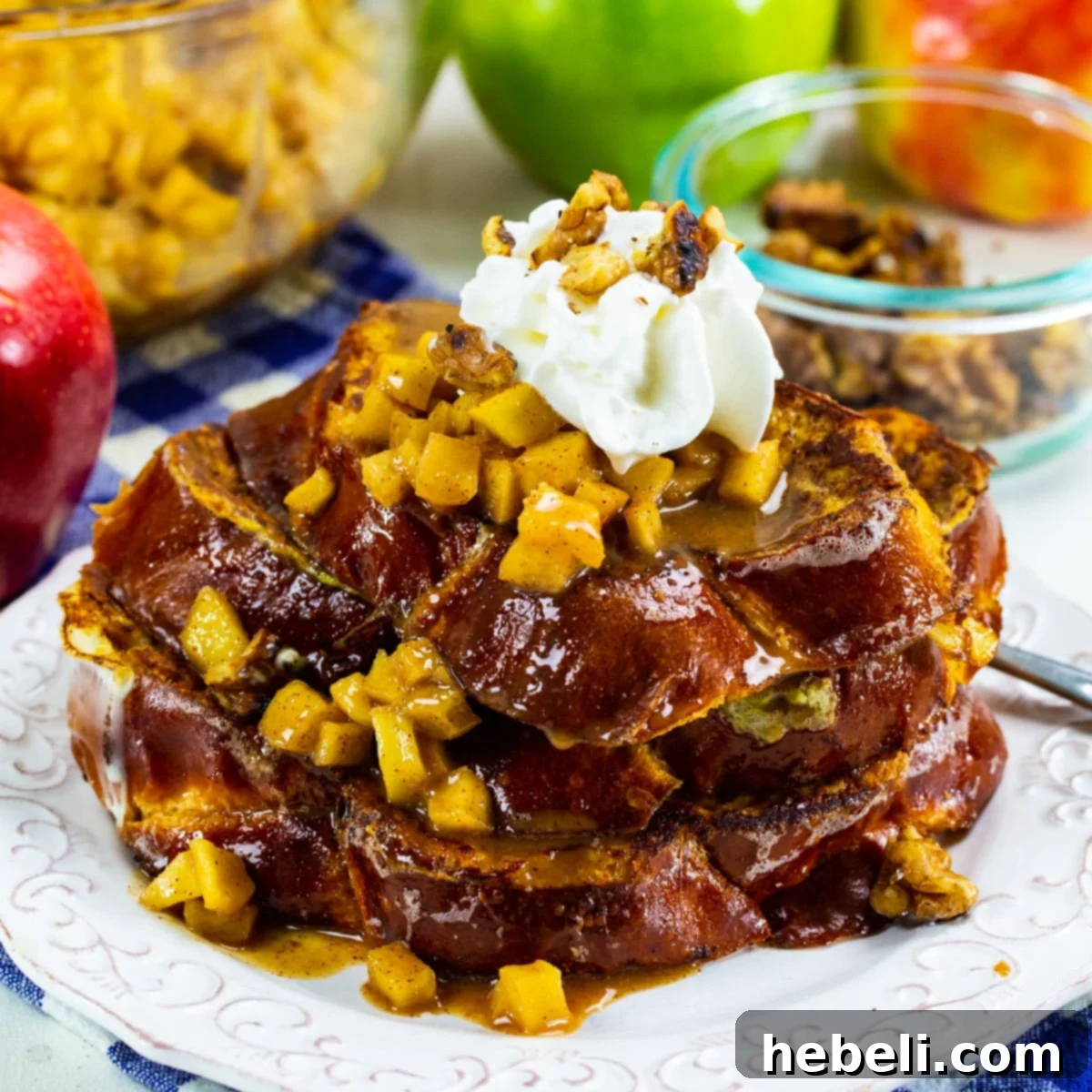 Caramel Apple French Toast on a plate, garnished with whipped cream and walnuts.