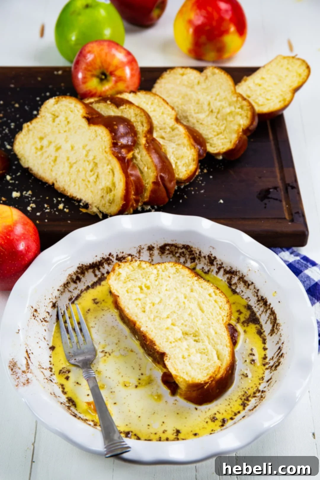 Thick slices of bread being dipped into an egg mixture for French Toast.
