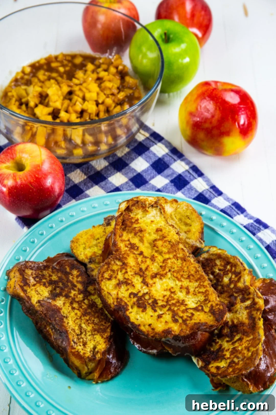 Perfectly cooked pieces of French toast stacked on a plate.