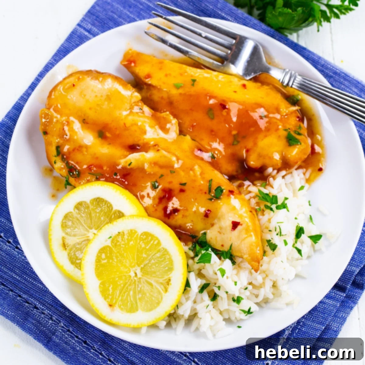 Zesty Slow Cooker Lemonade Chicken 2 Slow Cooker Lemonade Chicken on a plate with rice.