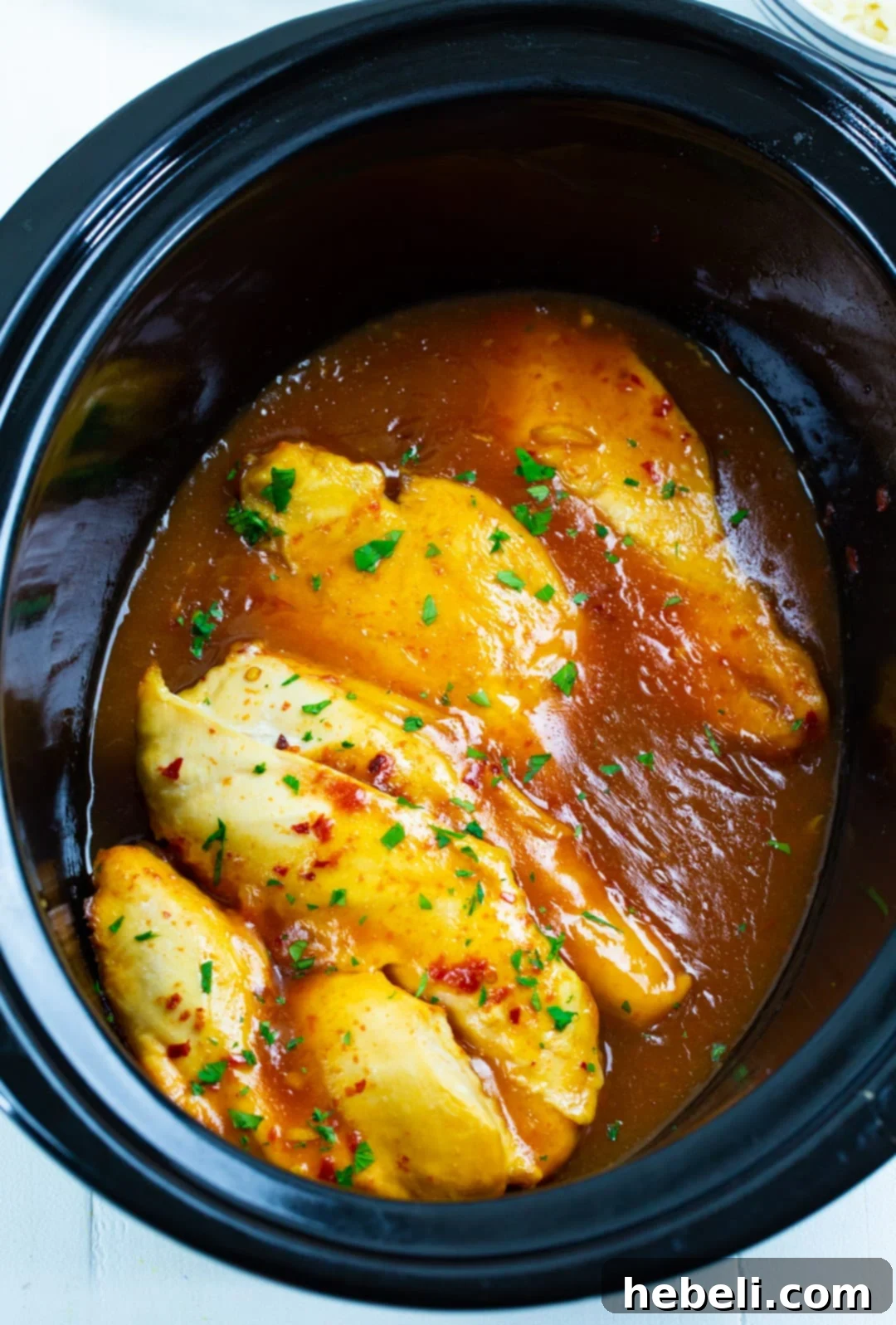 Zesty Slow Cooker Lemonade Chicken 3 Lemonade Chicken simmering in a slow cooker.