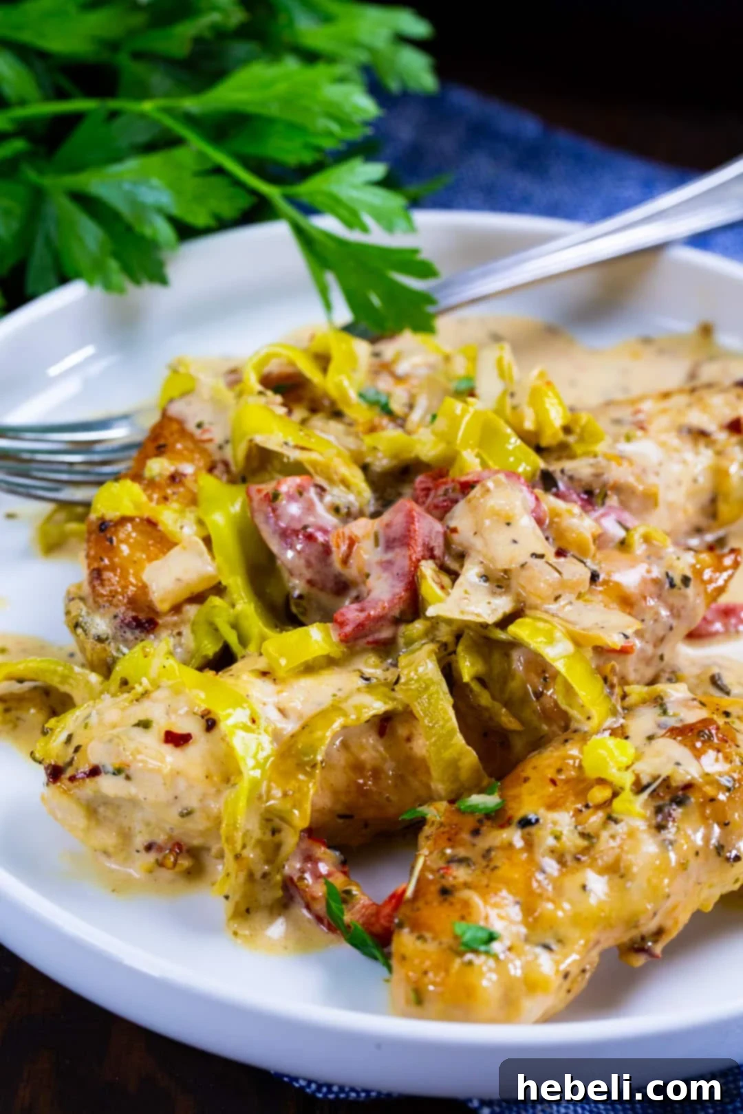 Creamy Pepperoncini Chicken dished up on a plate.