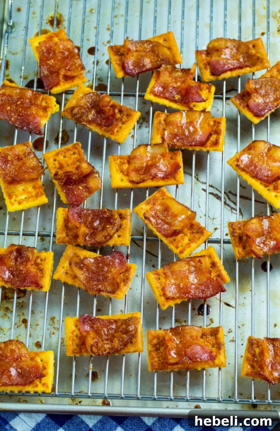 Sweet & Spicy Bacon Bites 4 Spicy Candied Bacon Crackers cooling on a wire rack after baking.