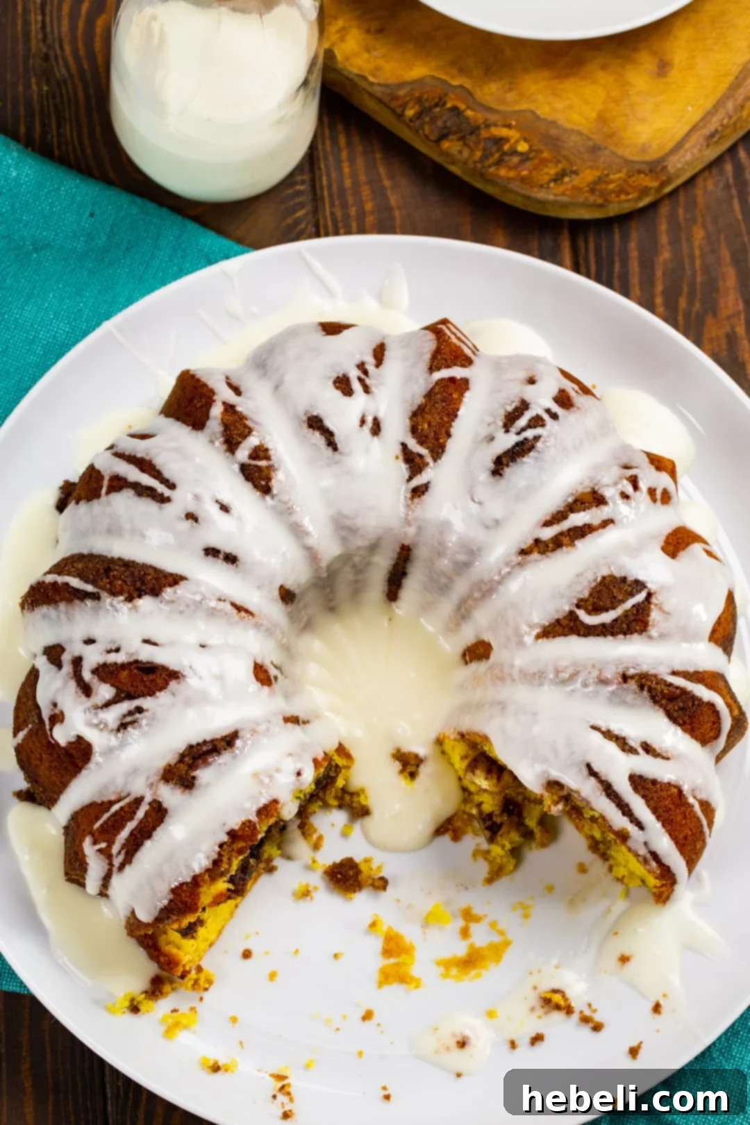 Honey Bun Bundt Cake with a few slices cut away on a serving plate.