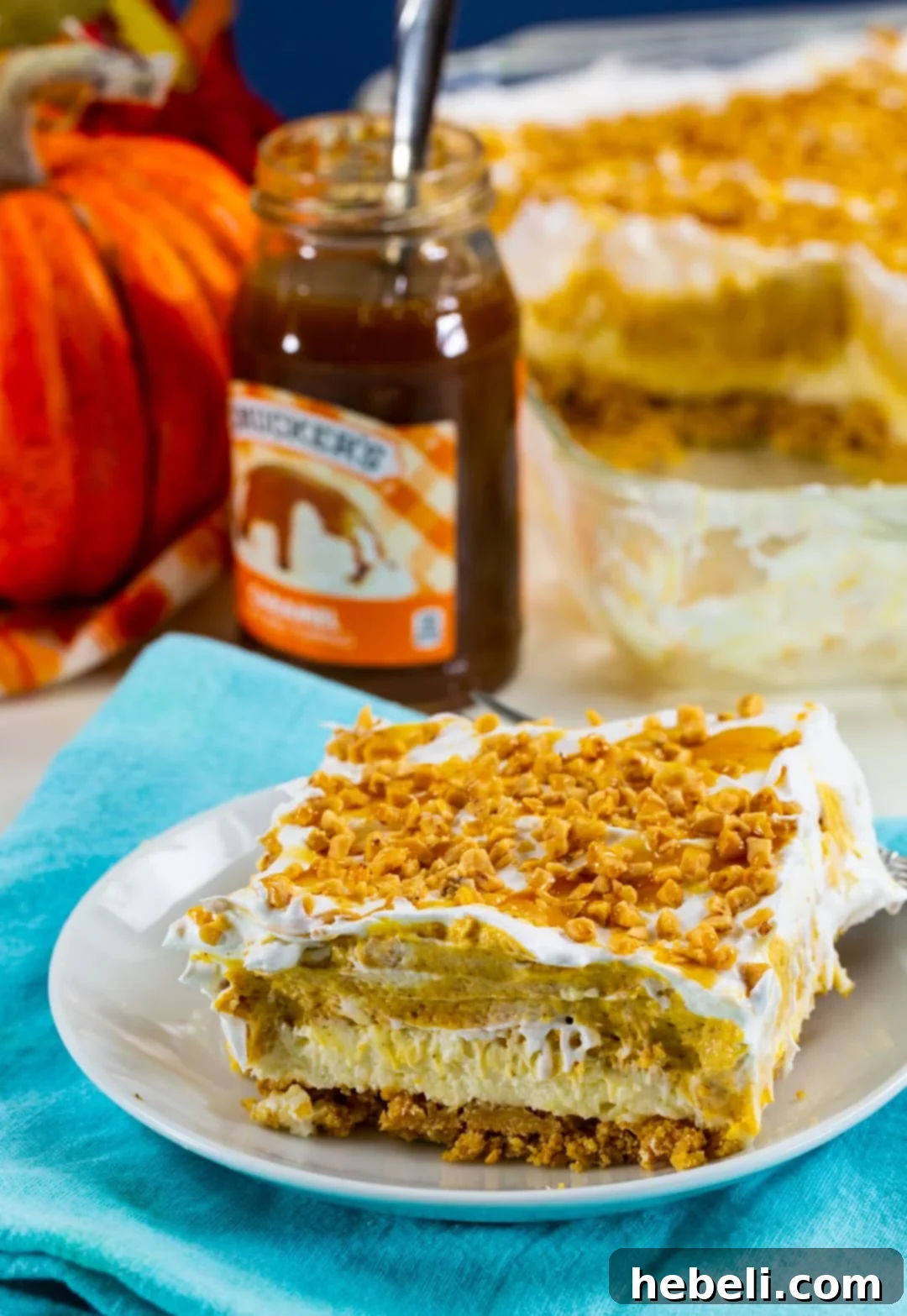 Decadent Pumpkin Delight 6 A perfectly cut square of Pumpkin Lush, showing all four distinct layers, served elegantly on a small white plate.