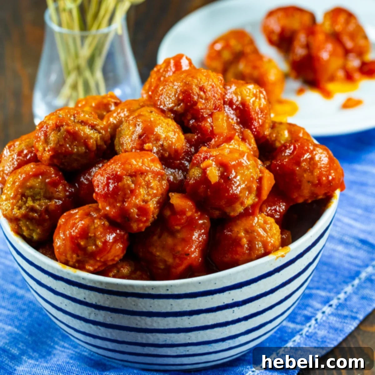Tender Slow Cooker BBQ Meatballs 2 Slow Cooker BBQ Meatballs in a serving bowl, glistening with sauce and ready to be enjoyed.